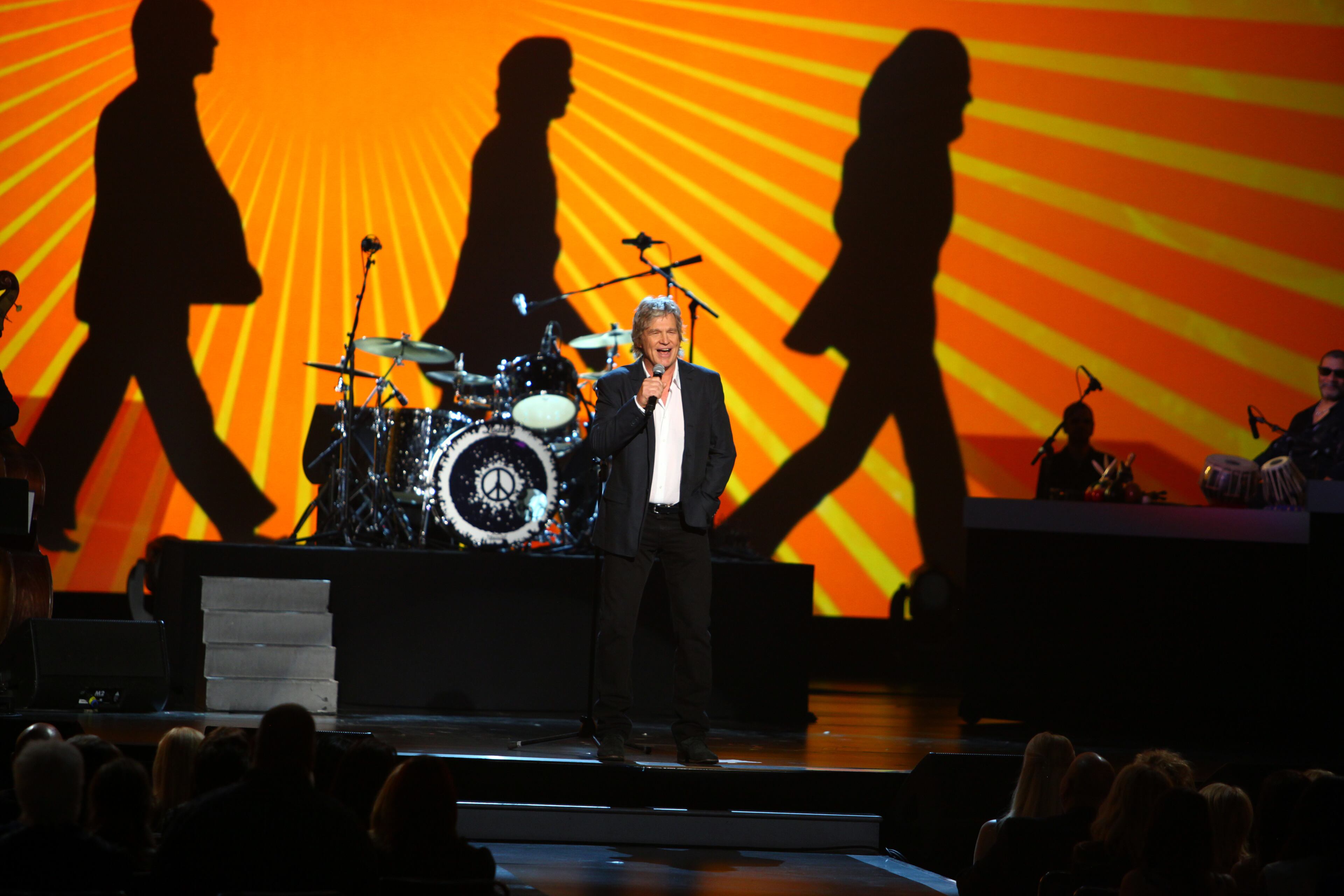 Jeff Bridges introduces Ringo Starr at The Night that Changed America: a Grammy Salute to the Beatles, on Monday, Jan. 27, 2014, in Los Angeles. (Photo by Zach Cordner/Invision/AP)