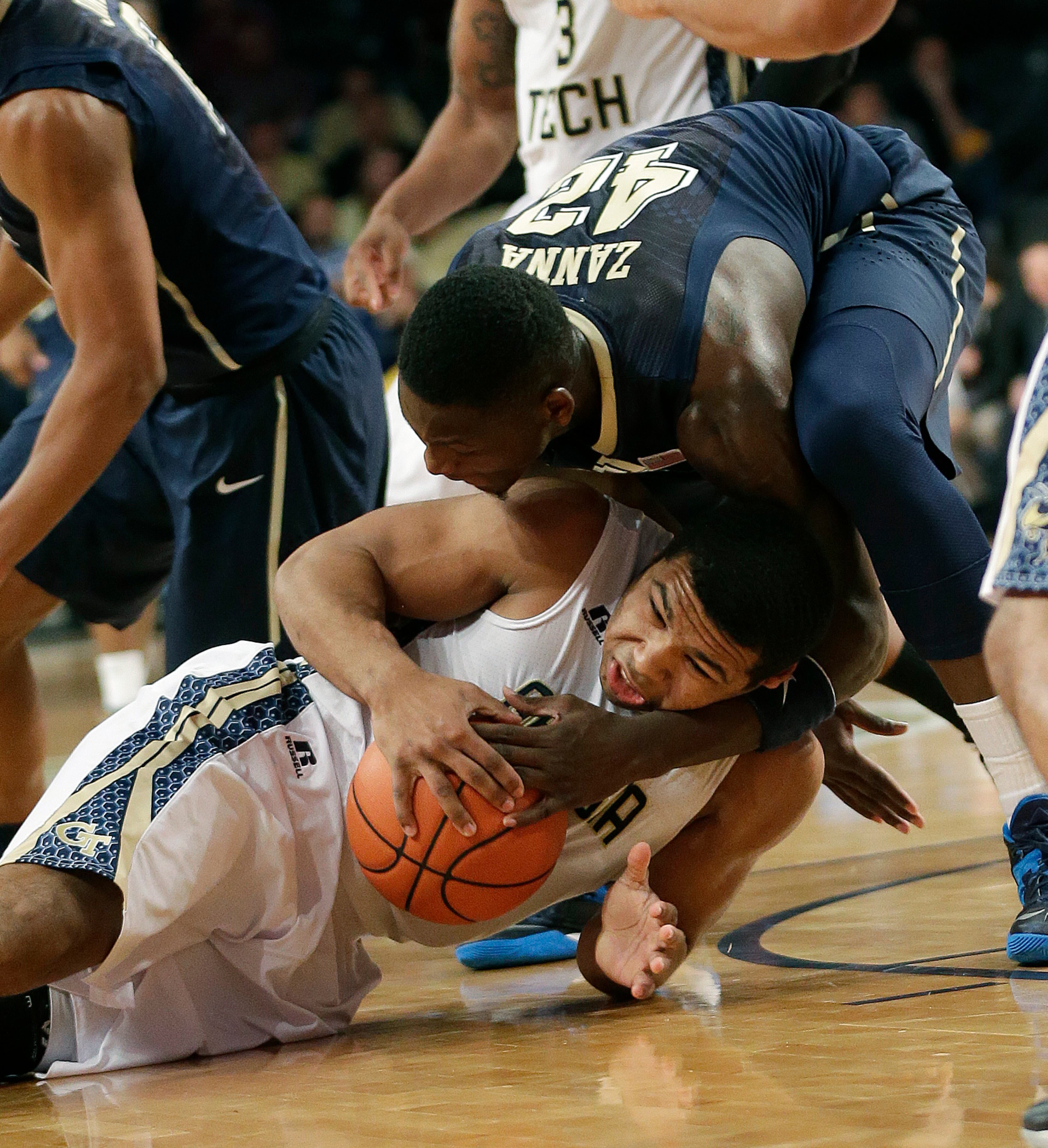 Georgia Tech guard Chris Bolden (11) and Pittsburgh forward Talib Zanna (42) scramble for a loose ball in the first half of an NCAA college basketball game Tuesday, Jan. 14, 2014, in Atlanta.