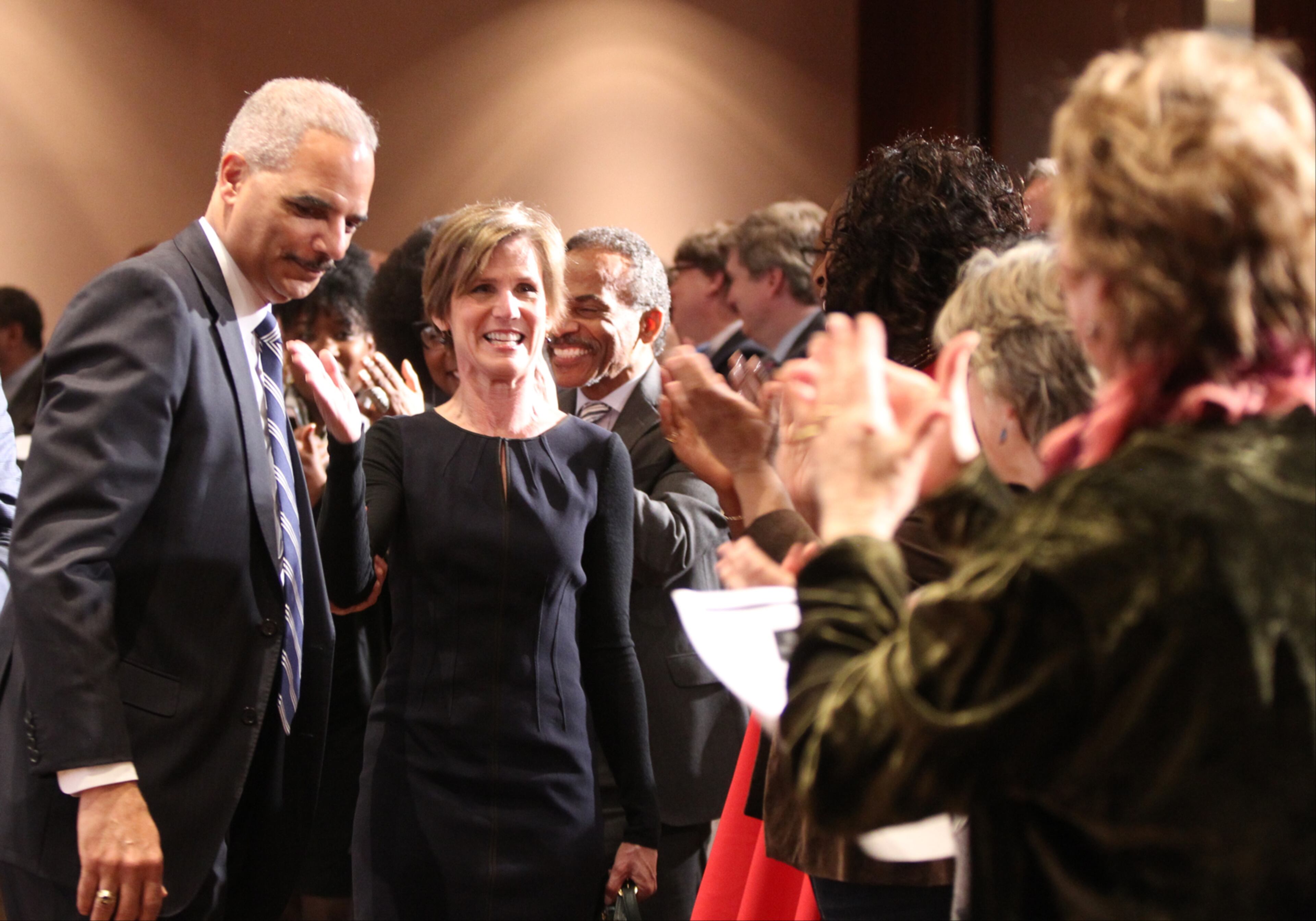 February 15, 2017, Atlanta, Georgia - Before taking her seat in the audience, former Attorney General Sally Yates points back at former Attorney General Eric Holder after he did the same to her moments before at the Jimmy Carter Presidential Library and Museum in Atlanta, Georgia, on Wednesday, February 15, 2017. (HENRY TAYLOR / HENRY.TAYLOR@AJC.COM)