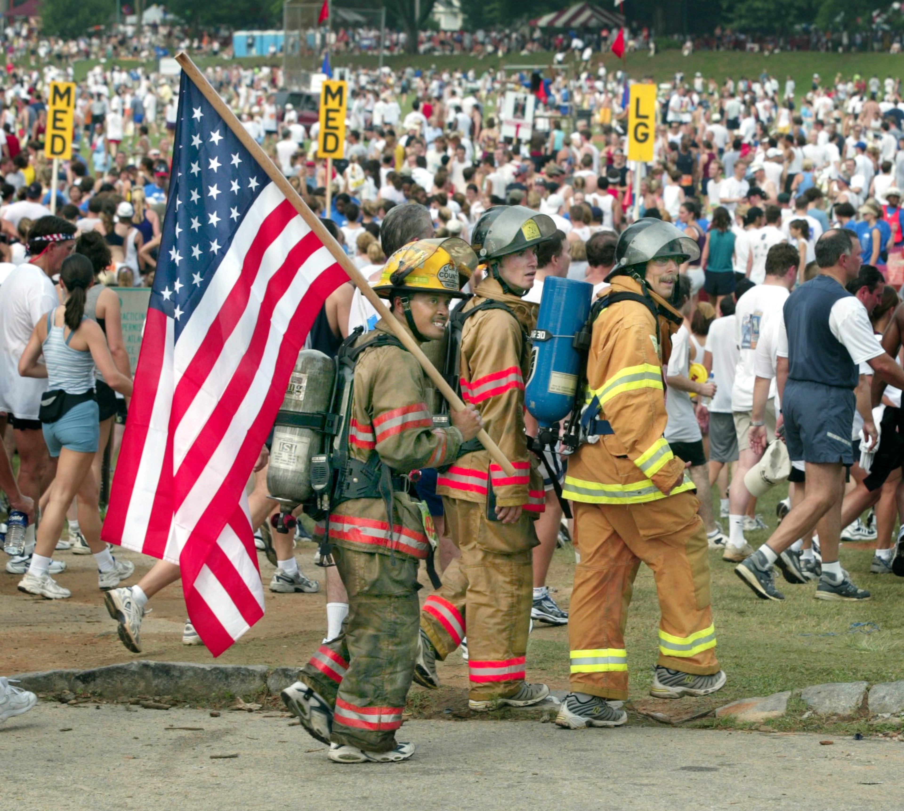 2002: Cobb County Firefighters (left to right) Met Clark, Scotty Pope and Johnny Buice ran the entire AJC Peachtree Road Race course in turn out gear and sneakers with empty airtanks as thousands of runners participated in 2002's race.