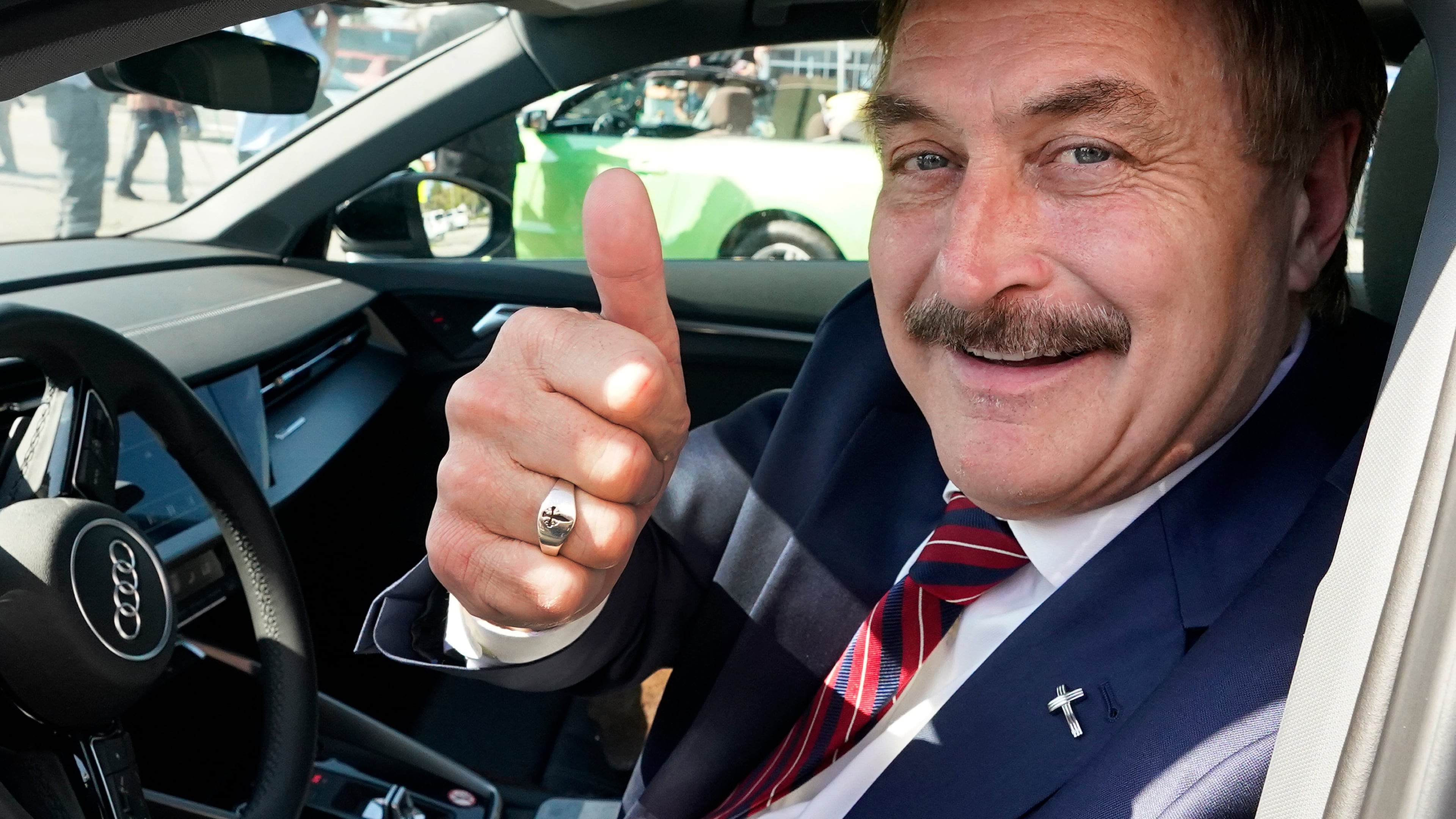 FILE - Mike Lindell gives a thumbs up as he passes by a rally for supporters of former President Donald Trump, April 4, 2023, in West Palm Beach, Fla. (AP Photo/Wilfredo Lee, File)