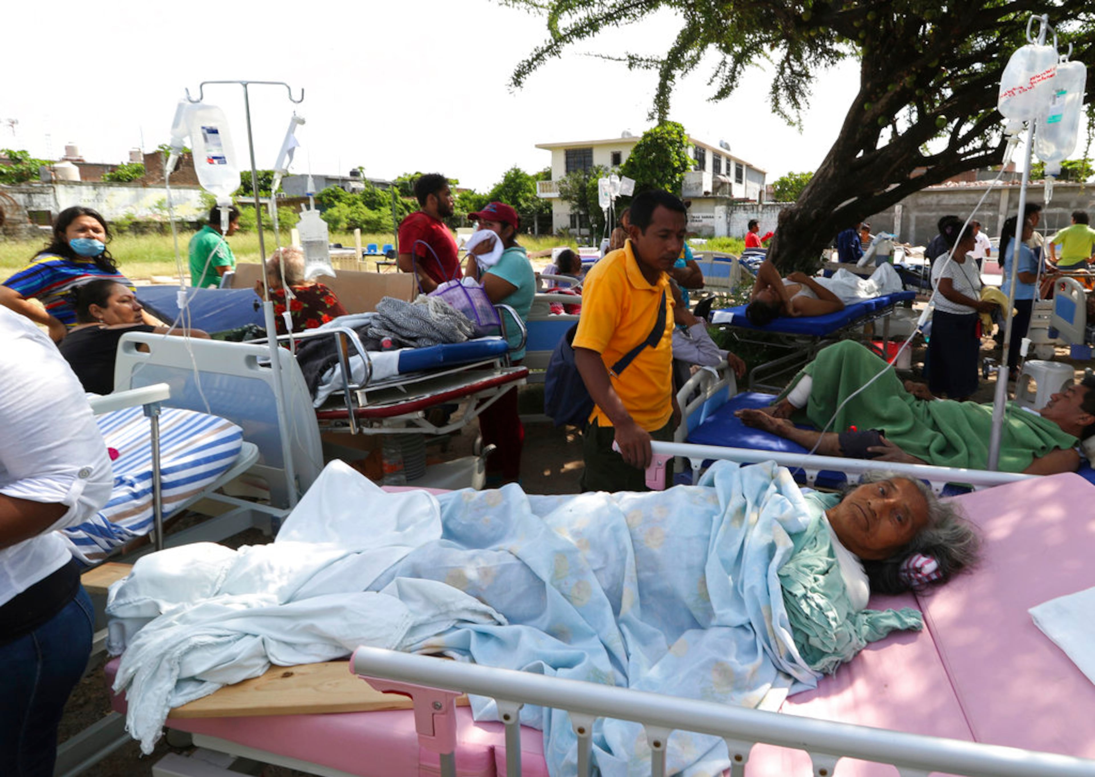 Evacuated patients lie on their hospital beds shaded by a tree, in the aftermath of a massive earthquake, in Juchitan, Oaxaca state, Mexico, Friday, Sept. 8, 2017. One of the most powerful earthquakes ever to strike Mexico hit off its southern Pacific coast, killing at least 32 people, toppling houses, government offices and businesses. (AP Photo/Luis Alberto Cruz)