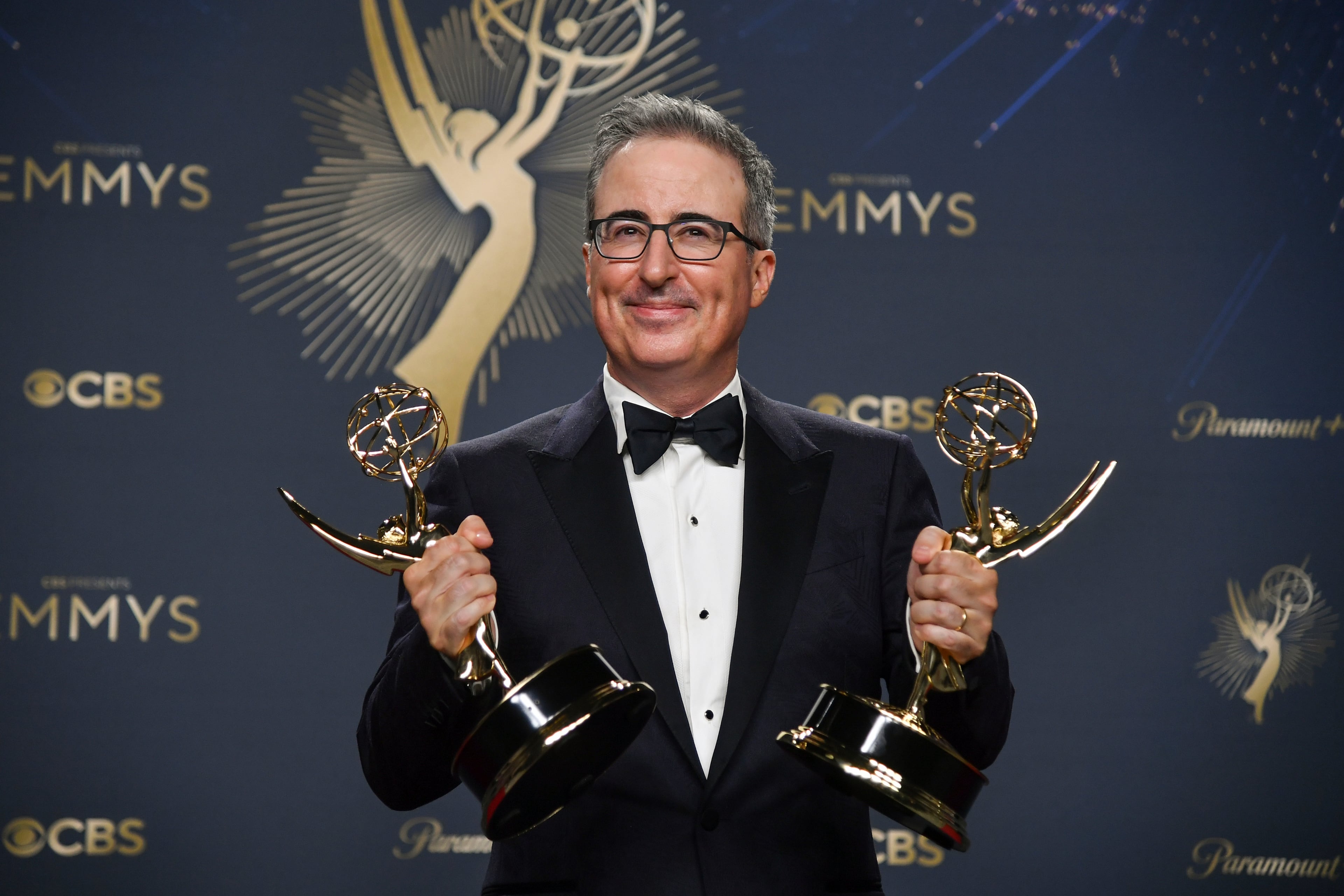 John Oliver, winner of the awards for outstanding writing for a variety series and outstanding scripted variety series for "Last Week Tonight with John Oliver," poses in the press room during the 77th Primetime Emmy Awards on Sunday, Sept. 14, 2025, at the Peacock Theater in Los Angeles. (Richard Shotwell/AP)