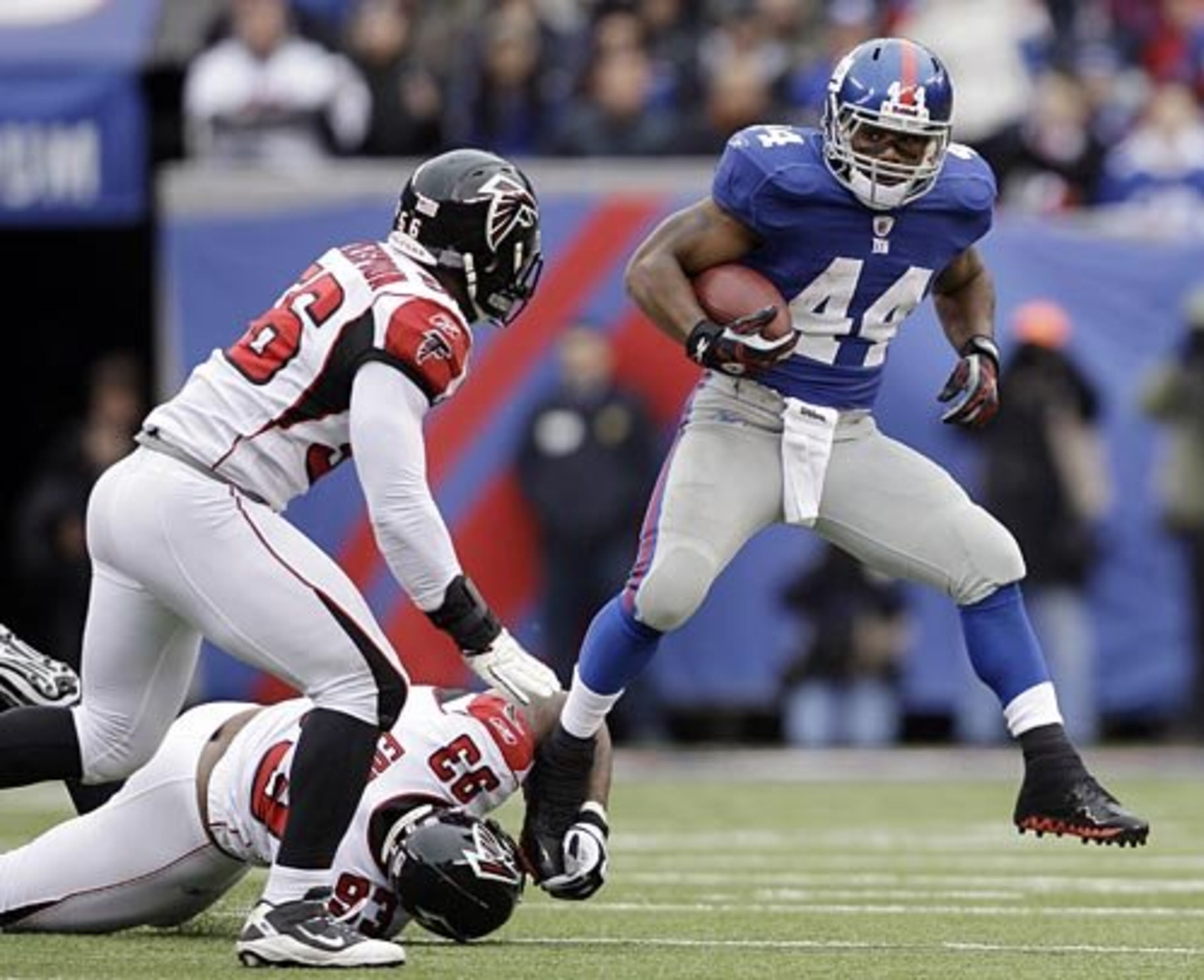 Giants running back Ahmad Bradshaw (44) evades tackles by Atlanta Falcons defensive end Ray Edwards (93) and Sean Weatherspoon.