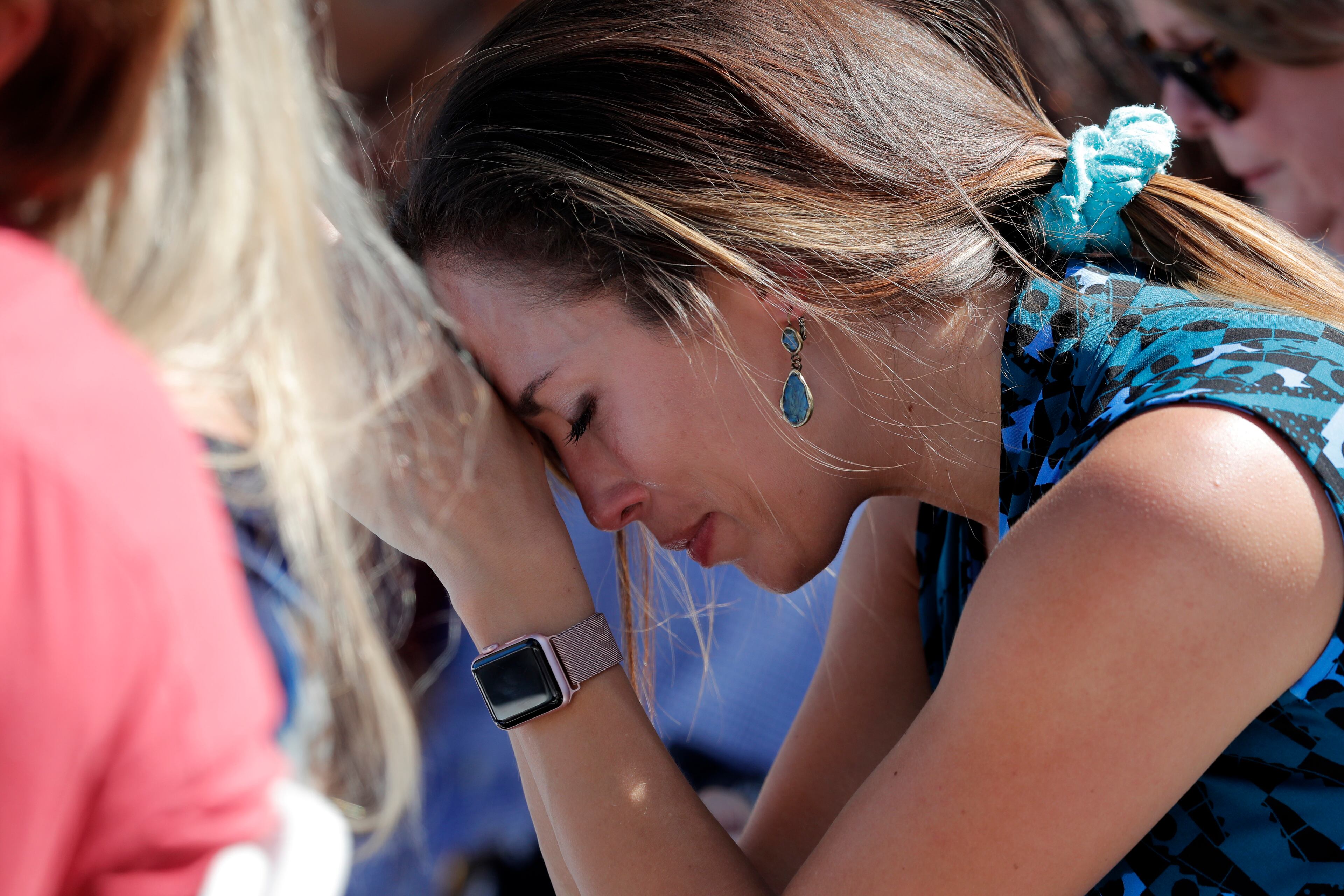 A woman cries as she bows her head in prayer during a vigil at the Parkland Baptist Church, for the victims of the Wednesday shooting at Marjory Stoneman Douglas High School, in Parkland, Fla., Thursday, Feb. 15, 2018. Nikolas Cruz, a former student, was charged with 17 counts of premeditated murder on Thursday. (AP Photo/Gerald Herbert)