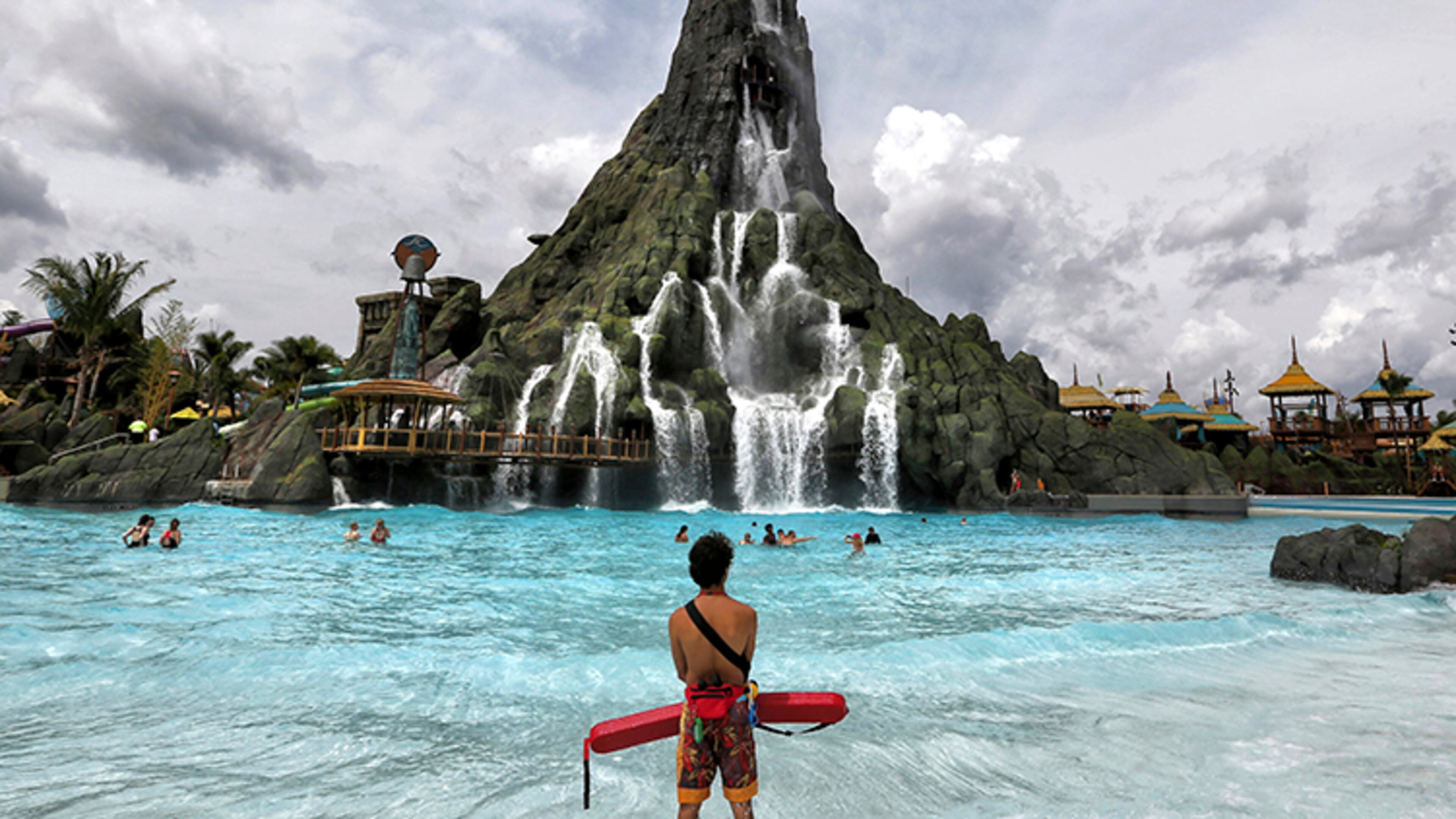 A lifeguard stands watch near the Krakatau volcano, the centerpiece water attraction at Universal Orlando's Volcano Bay. Federal investigators say the resort won't be cited for electrical problems that led to lifeguards getting shocked at its water park, saying the resort was unaware something was wrong. The report released this week said that five lifeguards reported receiving electric shocks last June at the Volcano Bay water park.