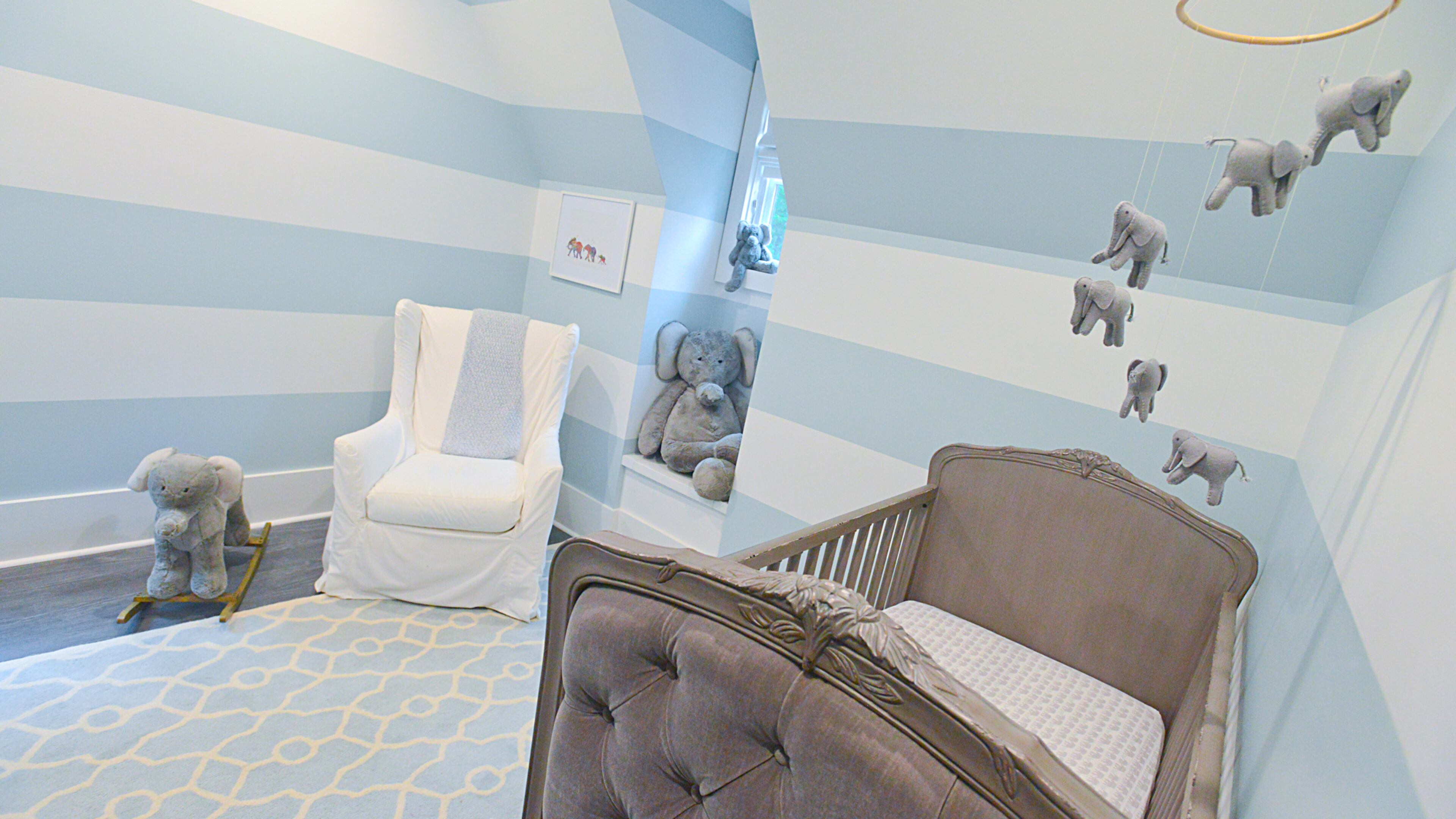 Lauren and John Kane didn't want to paint the nursery all one color, so they decorated son Connor's room with stripes to make the nursery feel larger. They alternated wide strips of white and silver-sage paint on the walls, and fitted their young son's room with furniture from RH (Restoration Hardware).