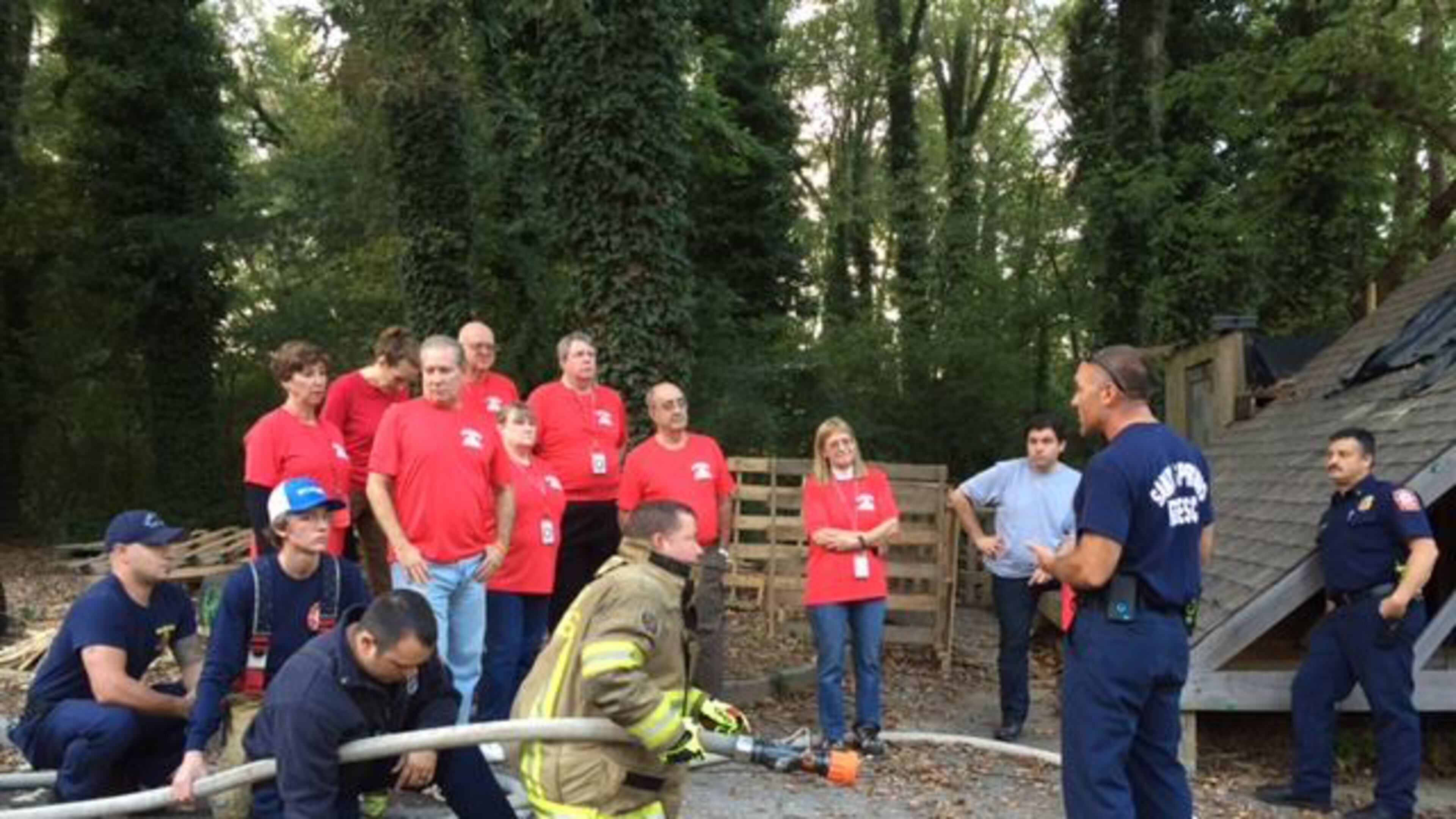 Participants in a past Sandy Springs Citizens Fire Academy learn about hose deployment from members of the Sandy Springs Fire Department. CITY OF SANDY SPRINGS
