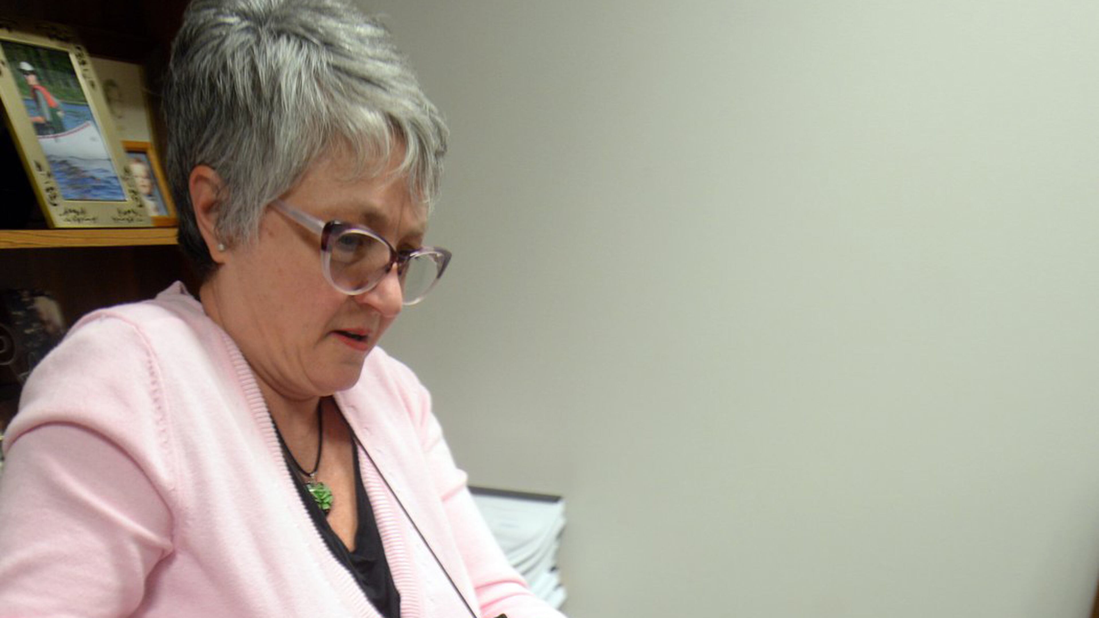 Fulton County Superior Court reporter Evelyn Parker, in her office on March 30, 2016, wrestles with a partially completed transcript from the Atlanta Public Schools trial. April 1st marks one year since the verdicts for the 12 APS educators who stood accused of engaging in a racketeering conspiracy to inflate test scores. The trial began on Aug. 11, 2014, with a jury-selection process that lasted six weeks. Now, the wait for transcripts and appeals is proving equally epic. KENT D. JOHNSON/ kdjohnson@ajc.com