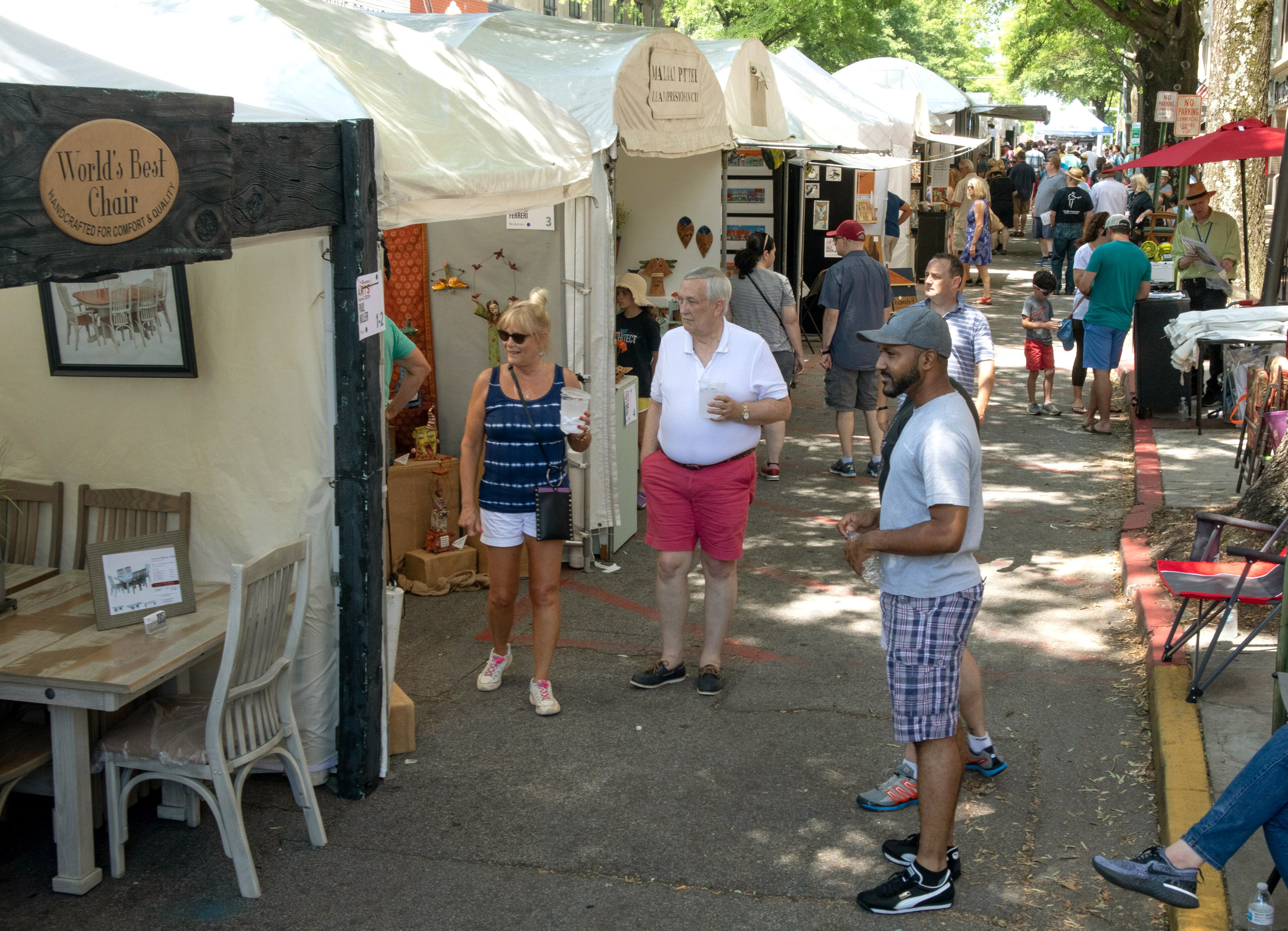 Fairgoers look over the artist booths during the annual Decatur Arts Festival on Sunday, May 26, 2019. STEVE SCHAEFER / SPECIAL TO THE AJC
