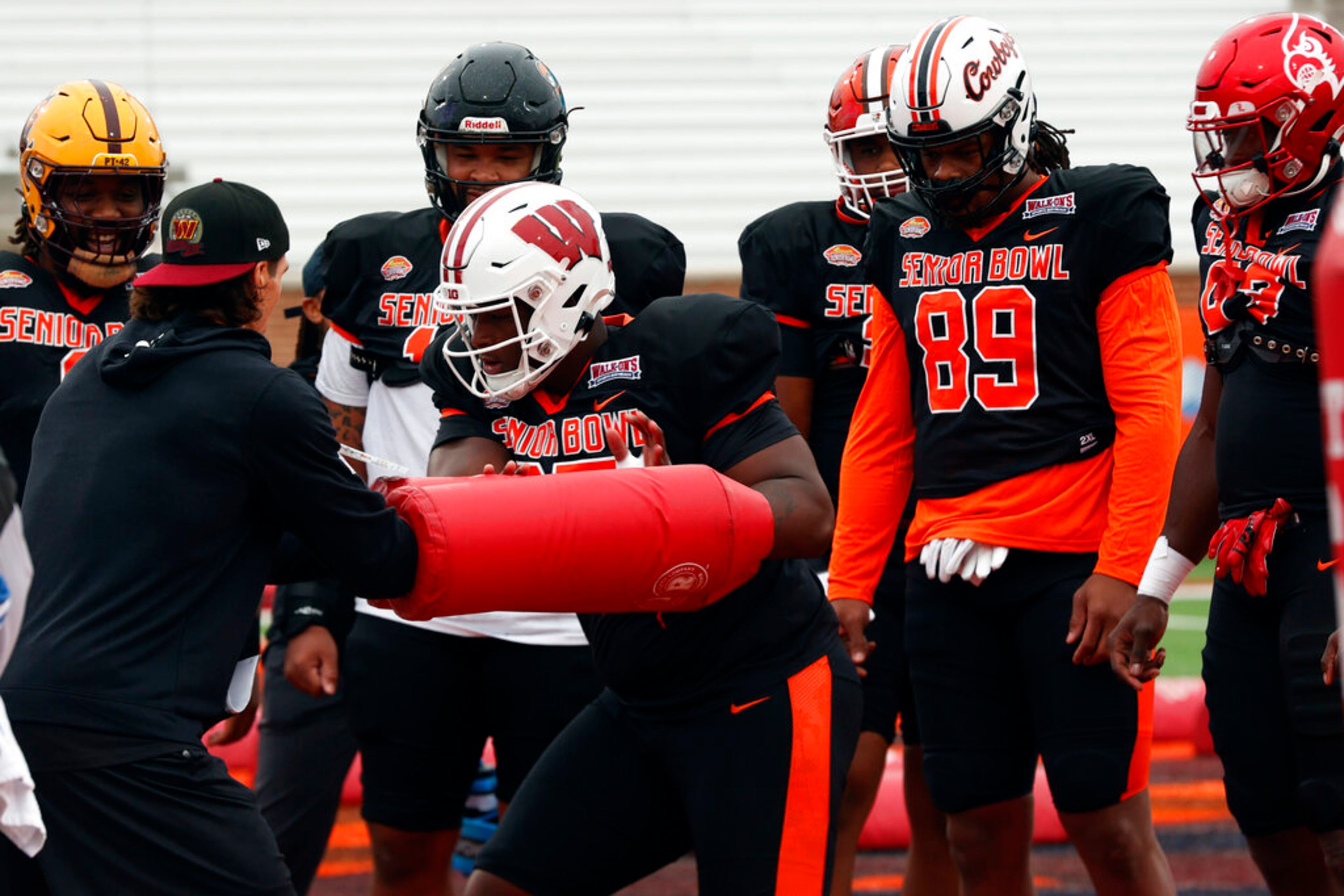 National defensive lineman Keeanu Benton of Wisconsin (95) runs through drills during practice for the Senior Bowl NCAA college football game Wednesday, Feb. 1, 2023, in Mobile, Ala.. (AP Photo/Butch Dill)