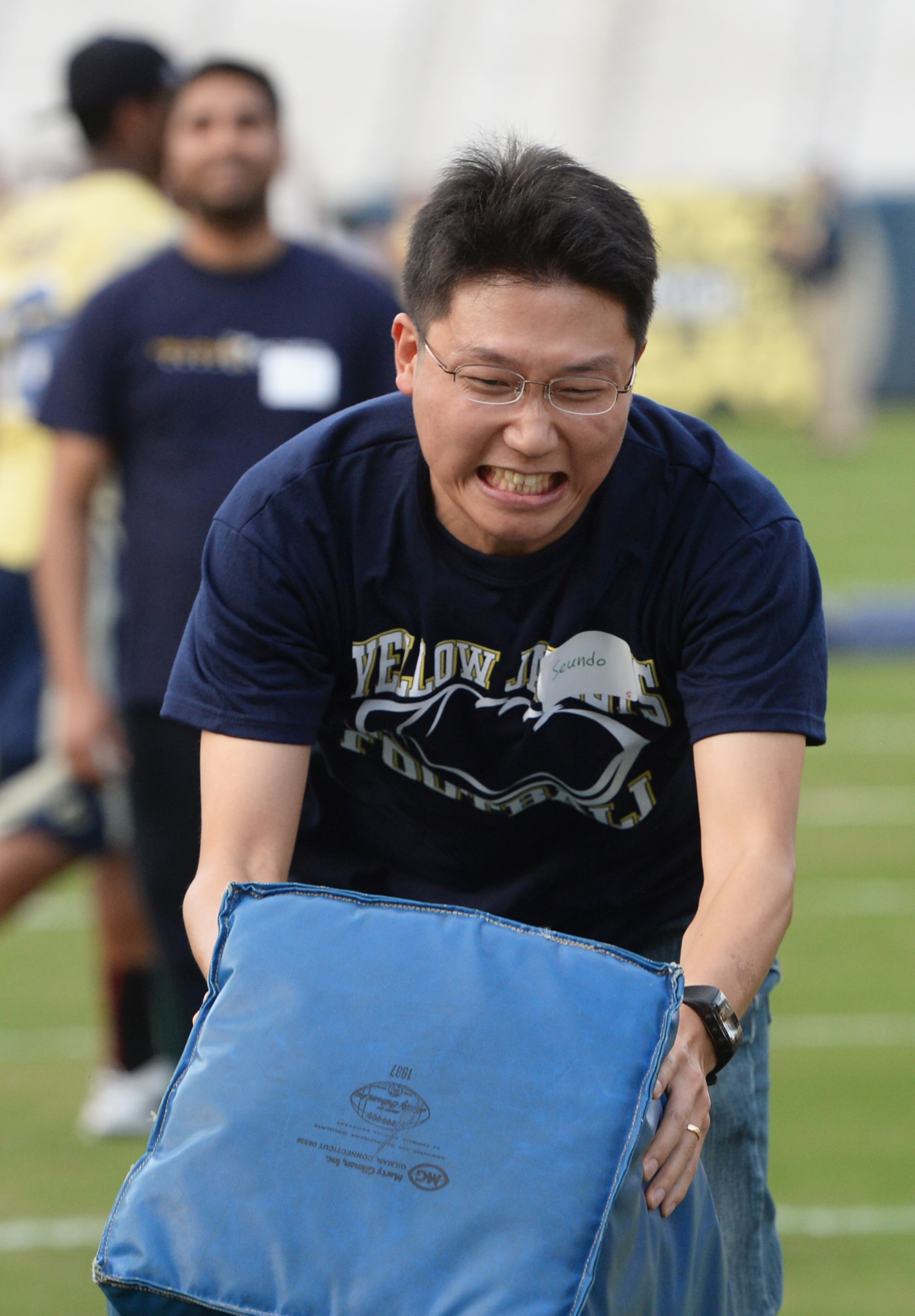 Seundo Heo, South Korea, tackles a football dummy.