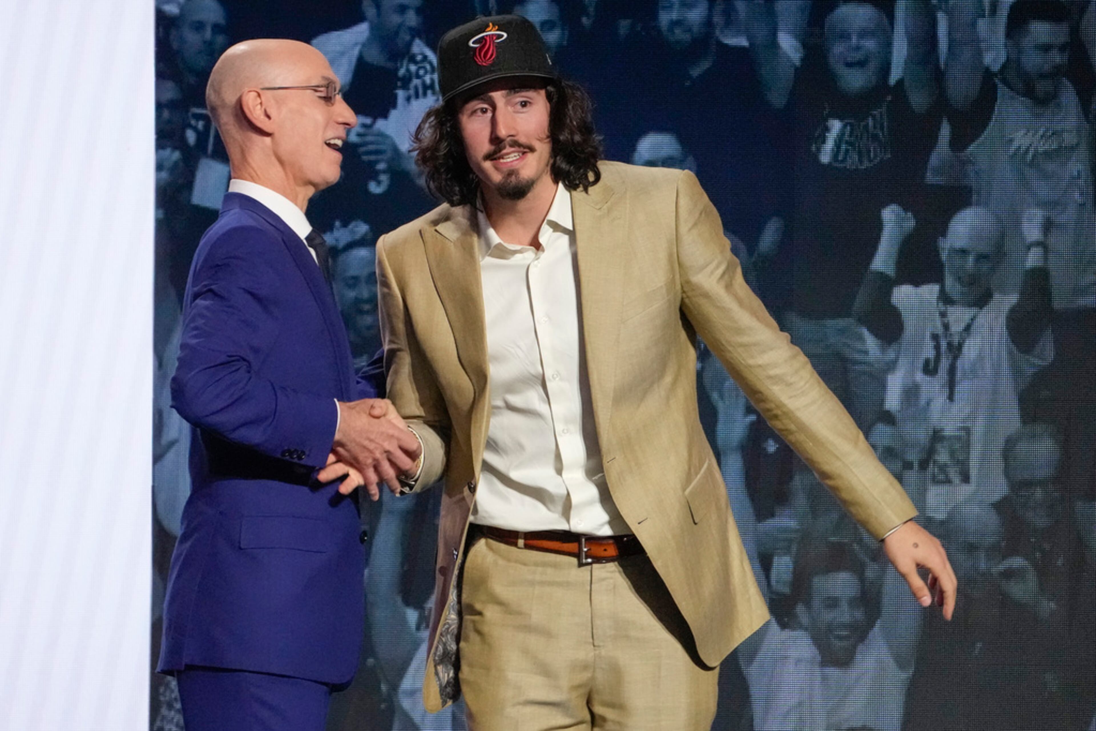 Jaime Jaquez Jr. greets NBA Commissioner Adam Silver after being selected 18th overall by the Miami Heat during the NBA basketball draft, Thursday, June 22, 2023, in New York. (AP Photo/John Minchillo)