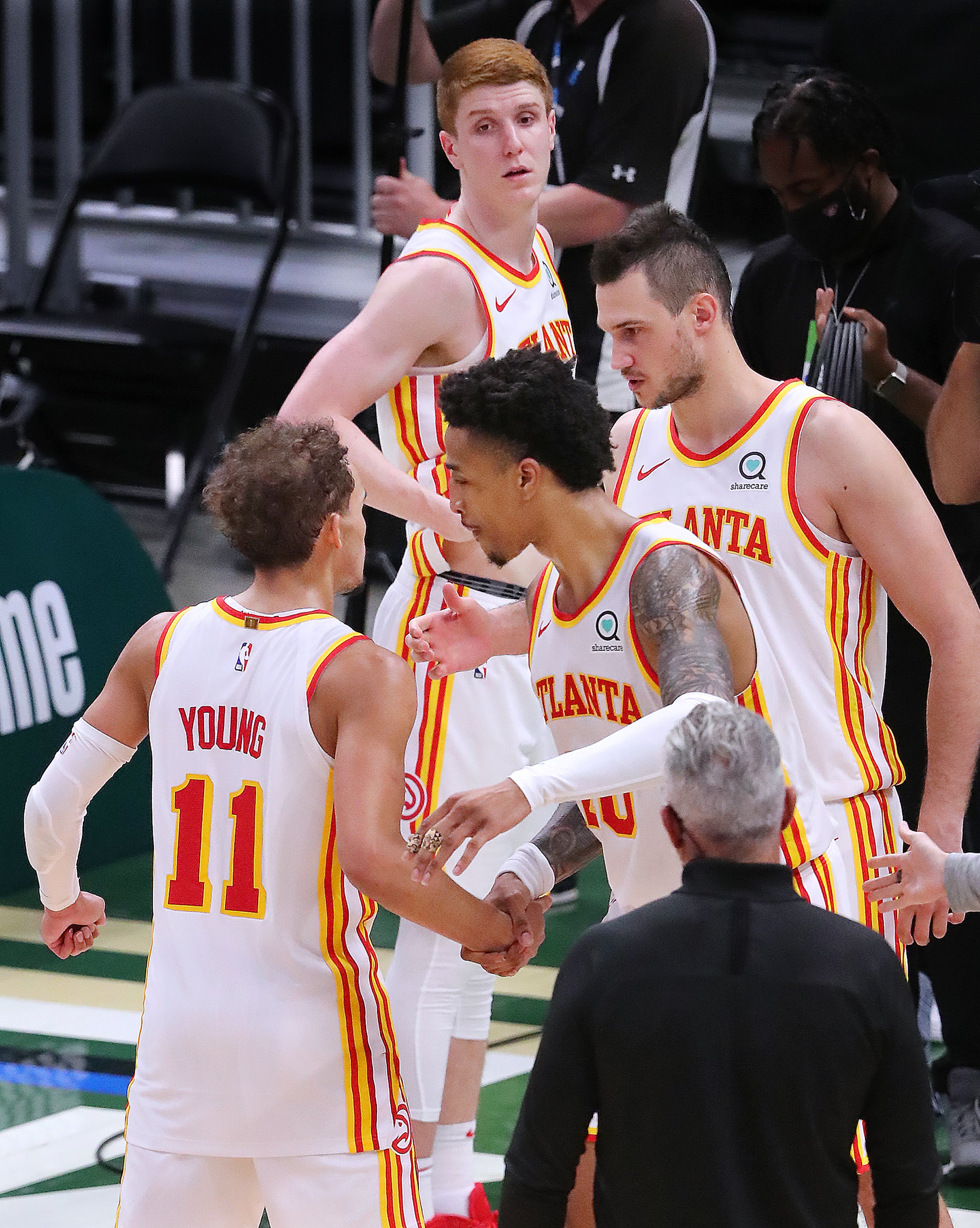 Hawks (clockwise from left) Trae Young, Kevin Huerter, Danilo Gallinari and John Collins celebrate as time expires in a 116-113 victory over the Milwaukee Bucks in game 1 of the NBA Eastern Conference Finals on Wednesday, June 23, 2021, in Milwaukee. “Curtis Compton / Curtis.Compton@ajc.com”