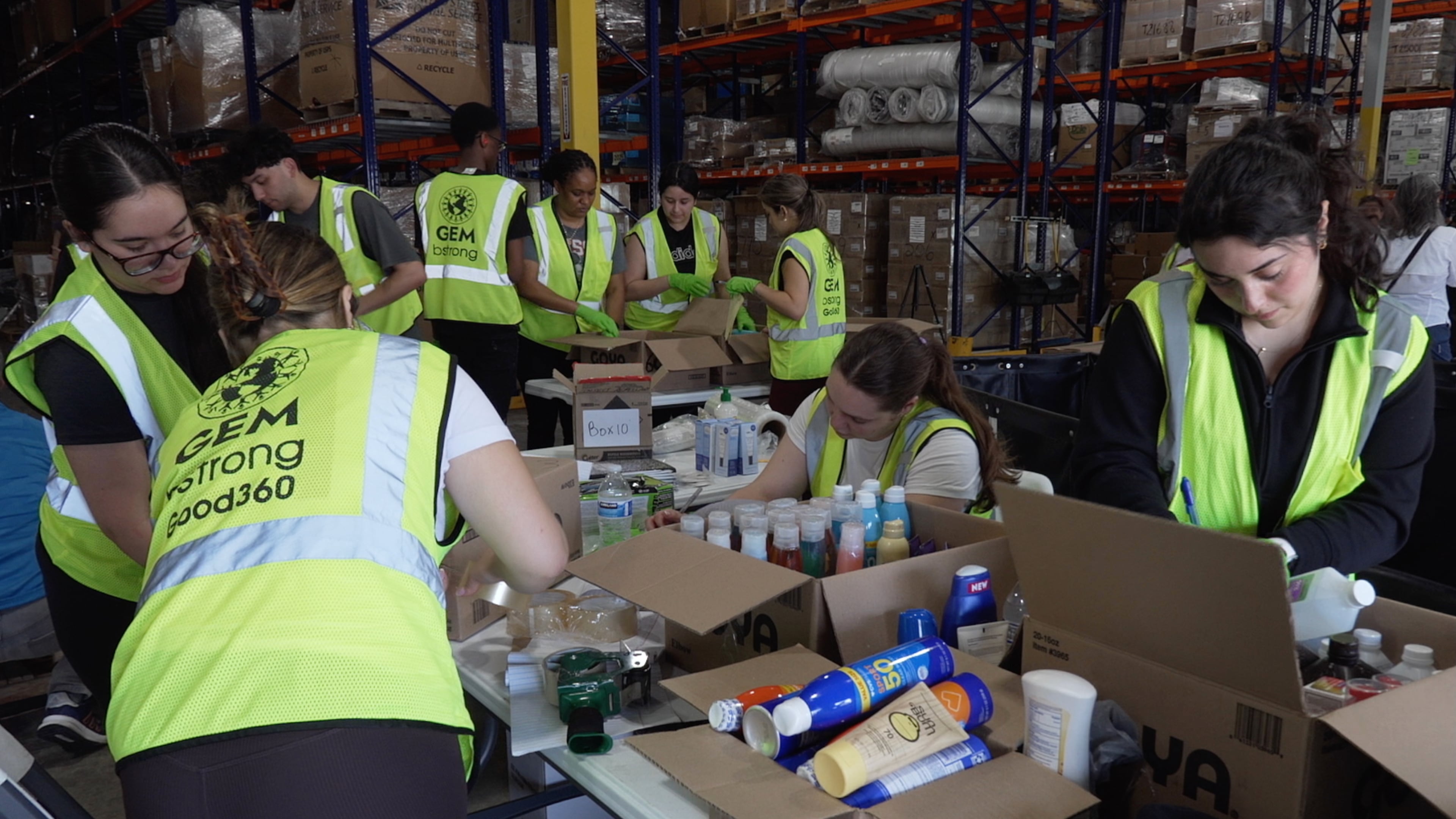 Volunteers are seen packaging supplies, Thursday, June 25, 2026, in Doral, Fla. (AP Photo/Cody Jackson)