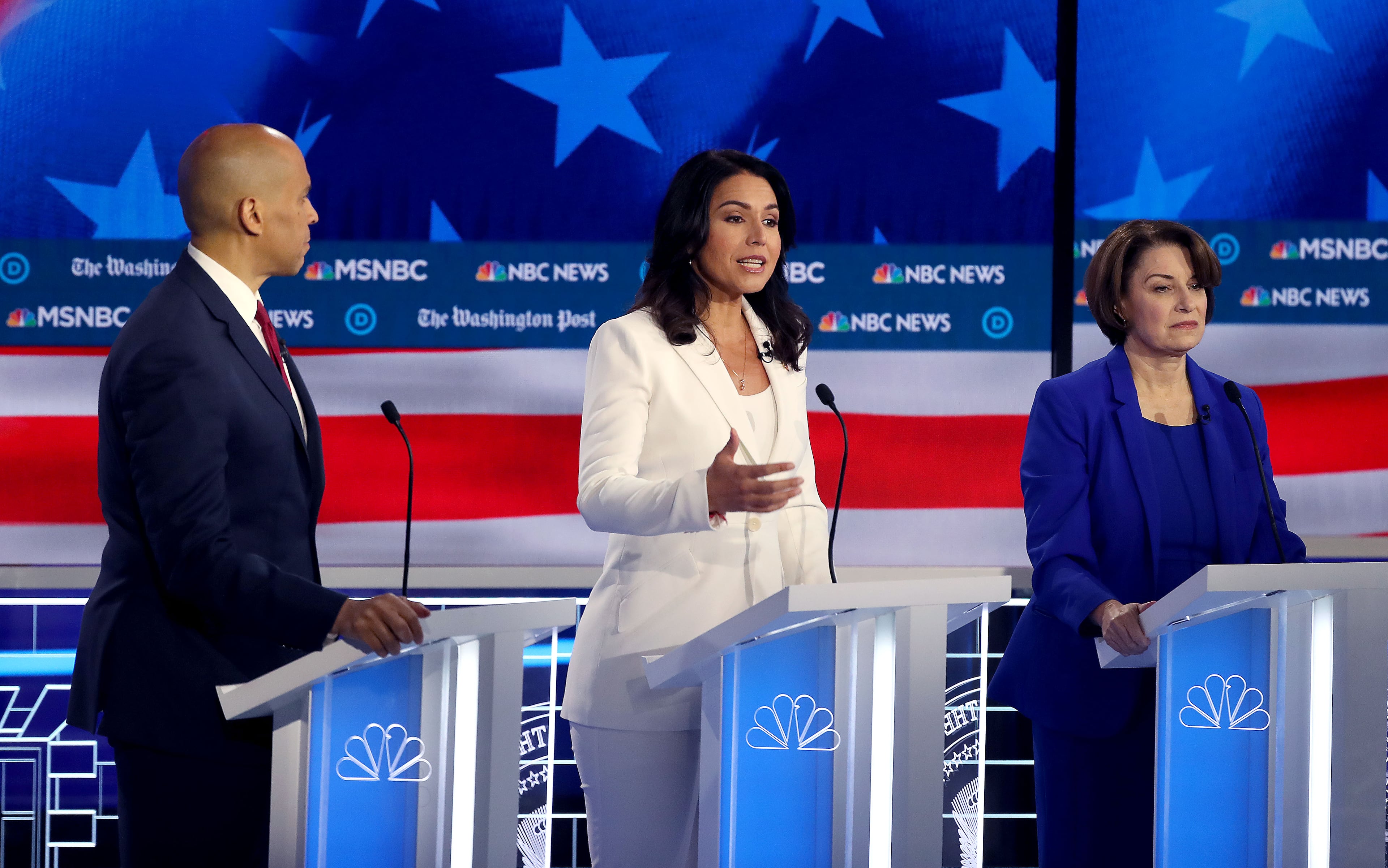 11/20/2019 -- Atlanta, Georgia -- Rep. Tulsi Gabbard (center) states her case as Senator Cory Booker (left) looks on, during the MSNBC/The Washington Post Democratic Presidential debate inside the Oprah Winfrey Soundstage at Tyler Perry Studios, Monday, November 20, 2019. (Alyssa Pointer/Atlanta Journal Constitution)