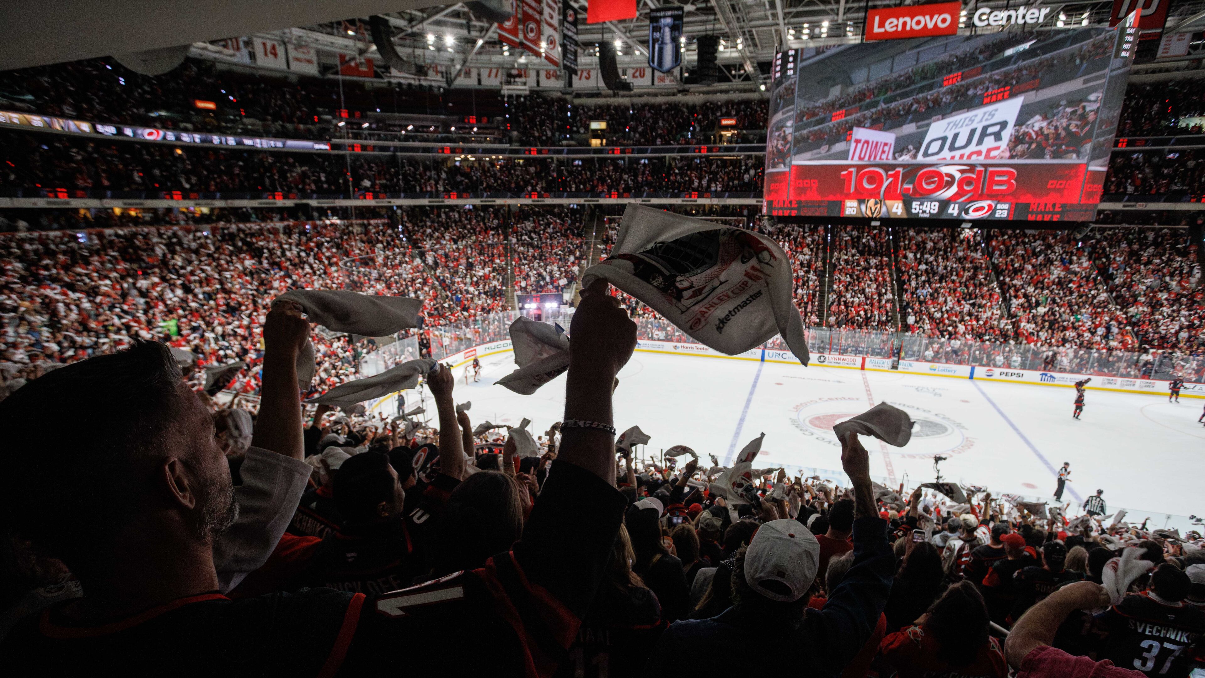 Fans at the Lenovo Center wave towels late in the third period in Game 1 of the NHL hockey Stanley Cup Final series between the Carolina Hurricanes and the Vegas Golden Knights in Raleigh, N.C., Tuesday, June 2, 2026. (AP Photo/Ben McKeown)