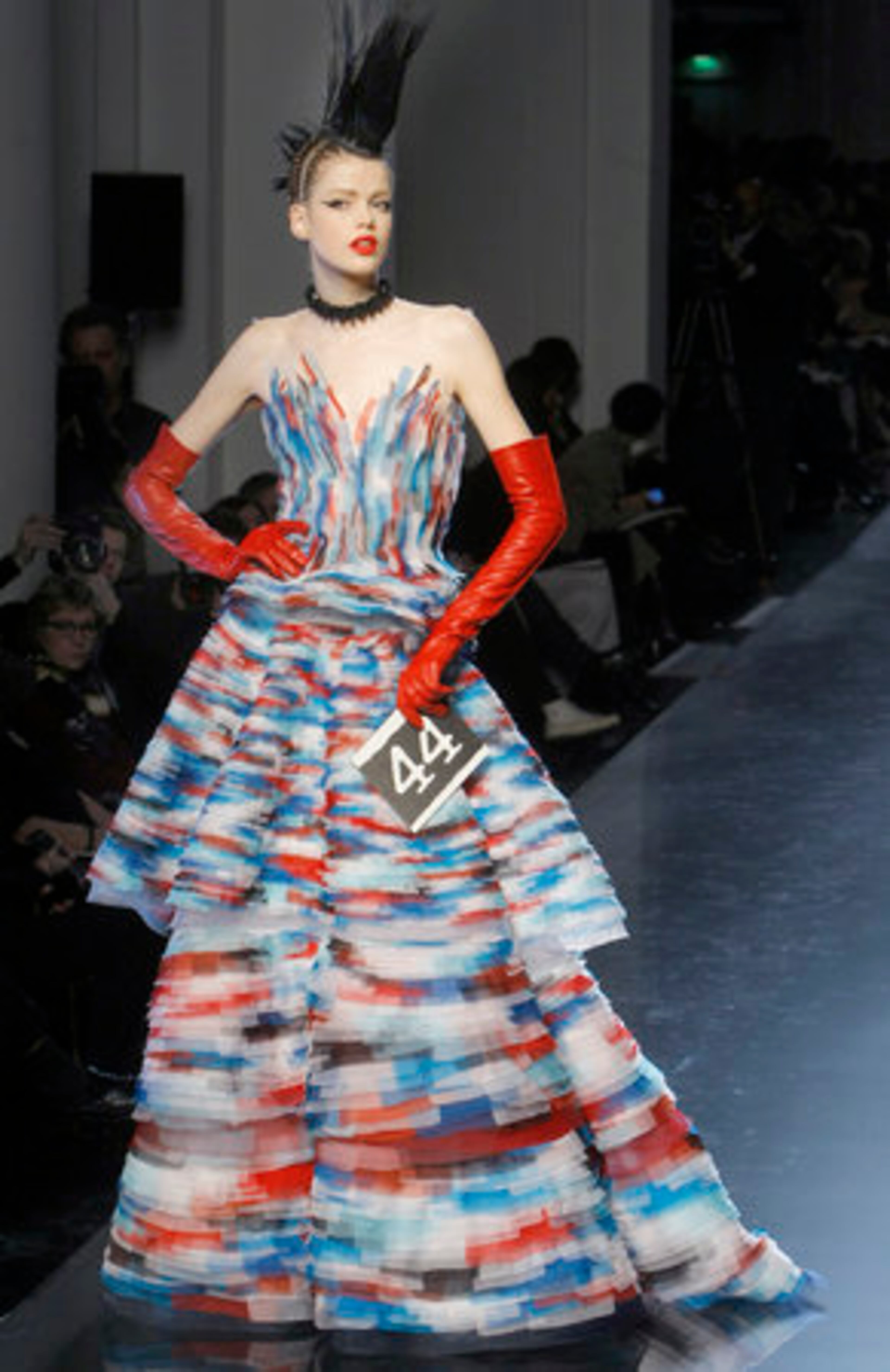 Proving he isn't afraid of color, Gaultier accessorized this sleeveless gown with red leather gloves.