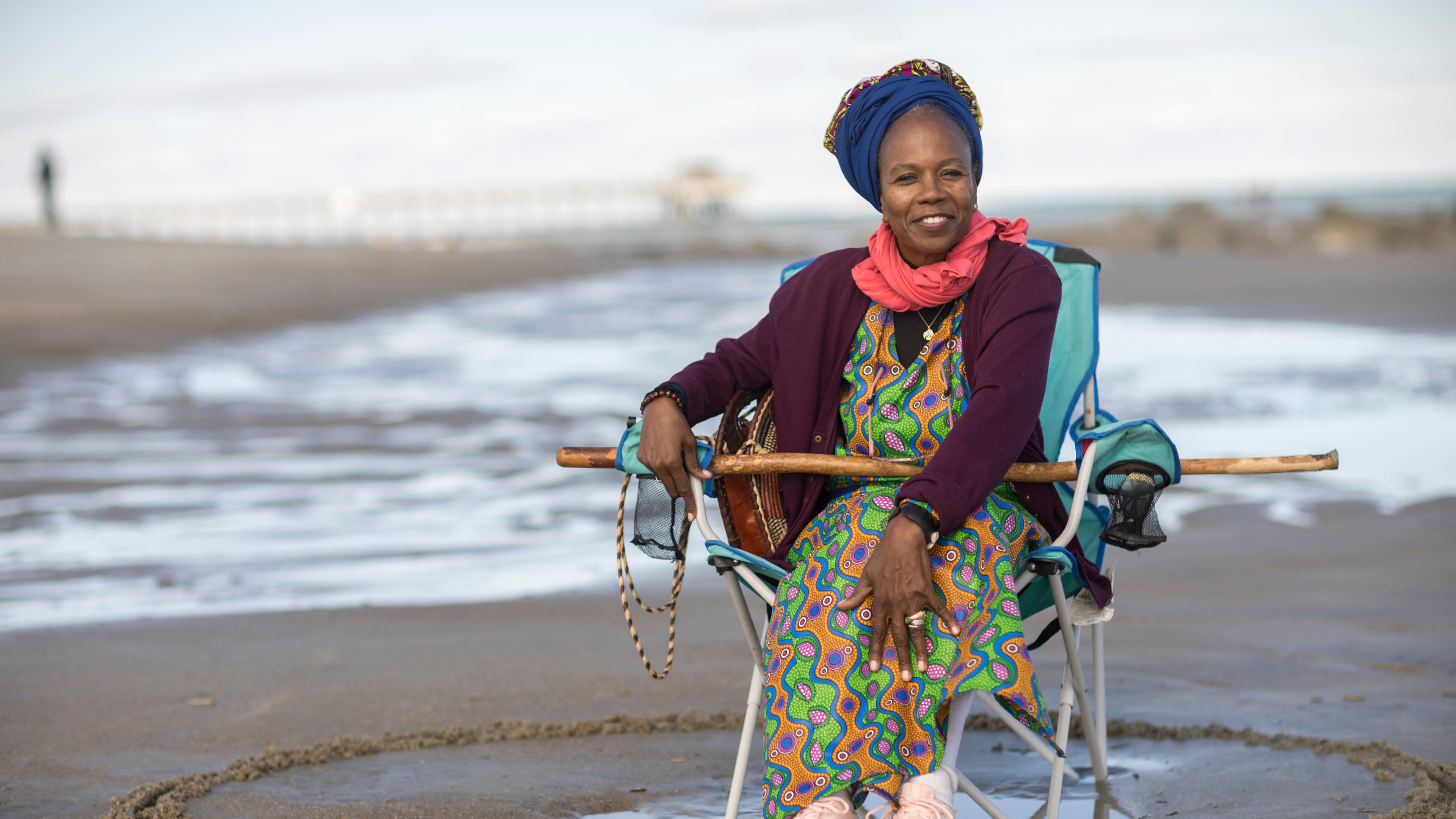 Julia Pearce, who's running for may of Tybee Island, sits in a full circle she drew around her beach chair. Pearce said she draws a circle as an acknowledgment to her community, her ancestors and a space for her friends to join her. (AJC Photo/Stephen B. Morton)