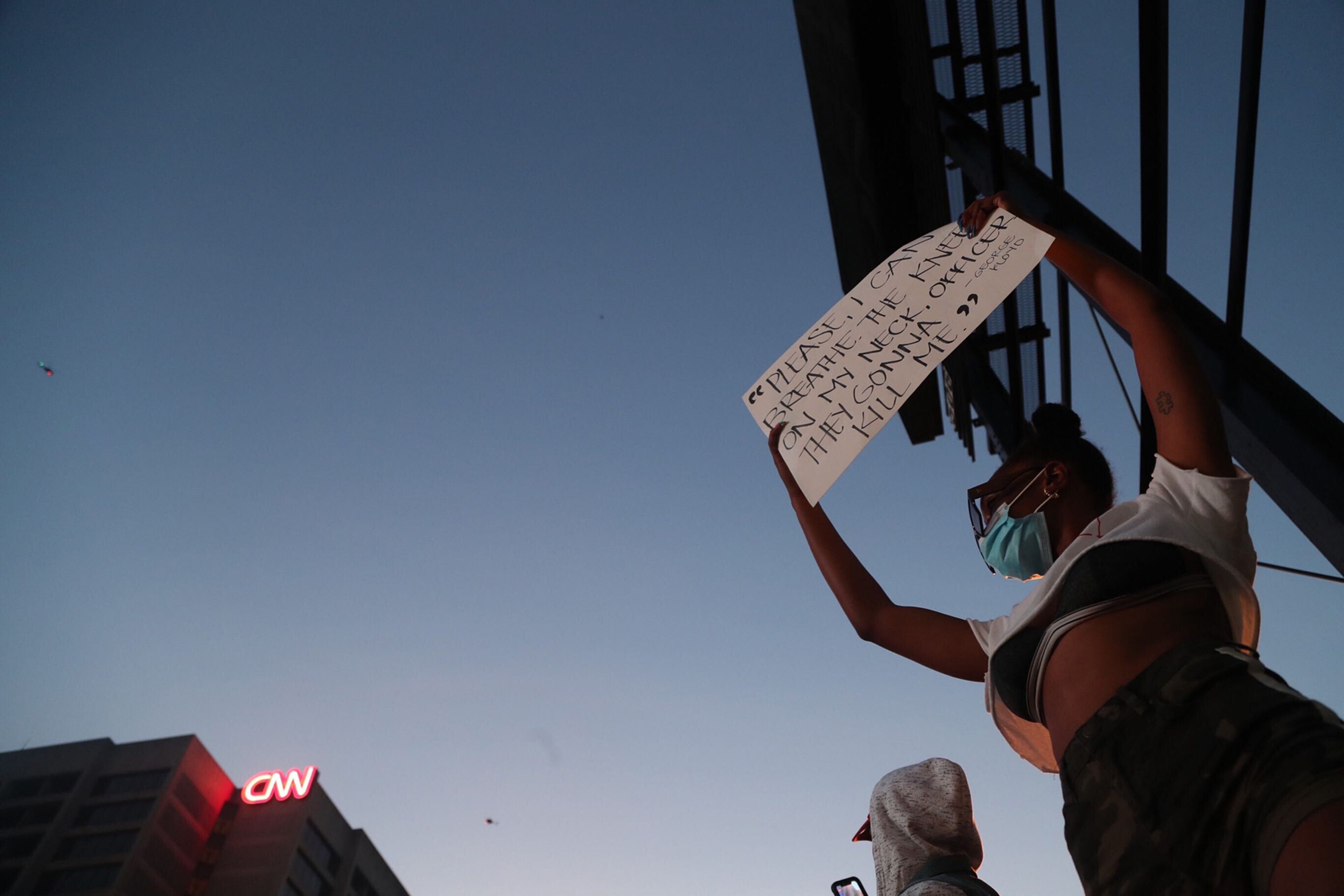 May 29, 2020 - Atlanta - After a peaceful march the Georgia State Capitol that swelled into the hundreds, protestors returned to the area around the Centennial Olympic Park and CNN center where some confronted police, who sprayed some demonstrators with pepper spray. They carried signs and chanted their messages of outrage over the death of George Floyd in Minneapolis. Alyssa Pointer / alyssa.pointer@ajc.com