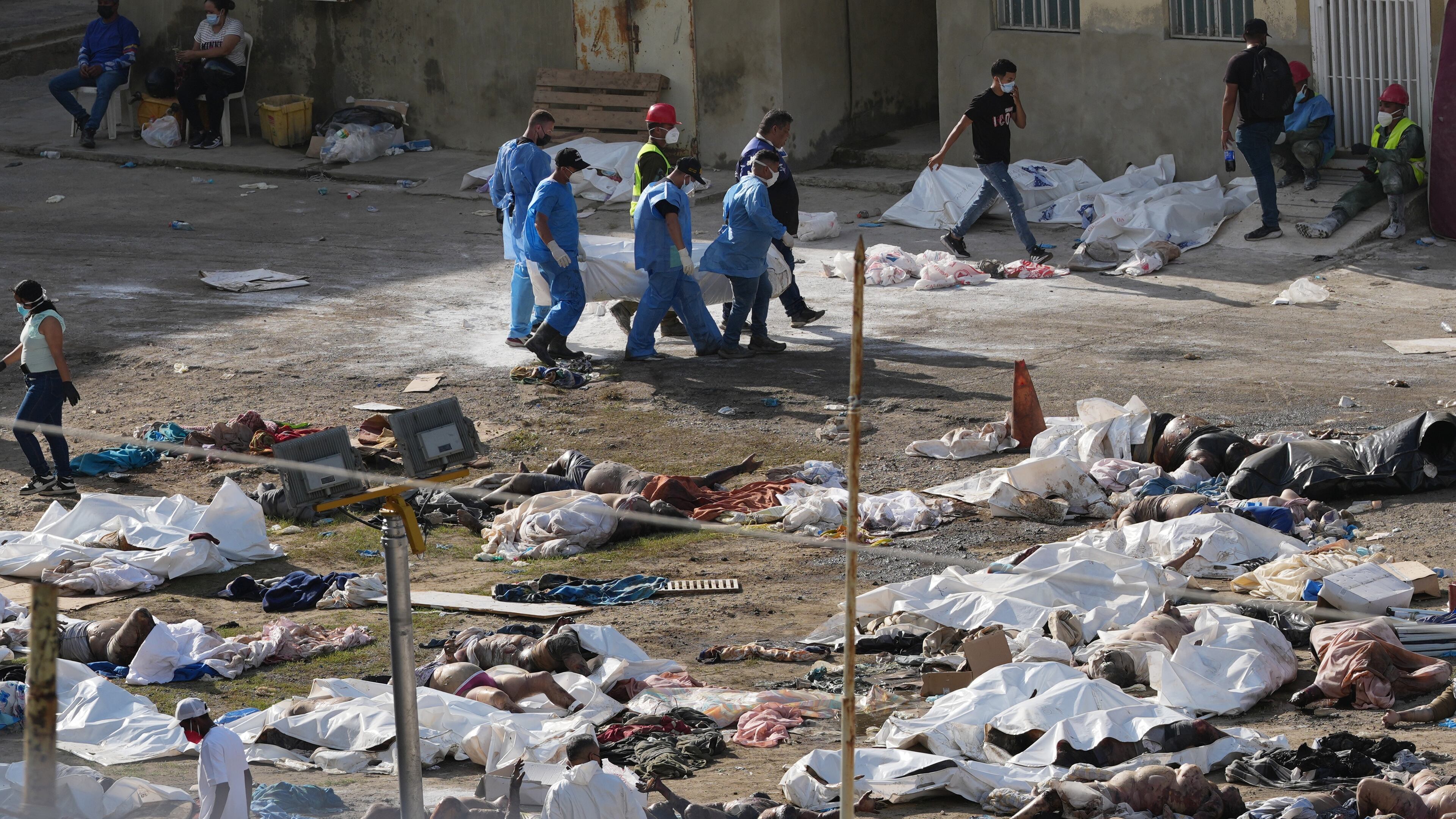 EDS NOTE: GRAPHIC CONTENT - Emergency workers gather the bodies of earthquake victims in the parking lot of a hospital three days after twin earthquakes struck, in La Guaira, Venezuela, Saturday, June 27, 2026. (AP Photo/Matias Delacroix)