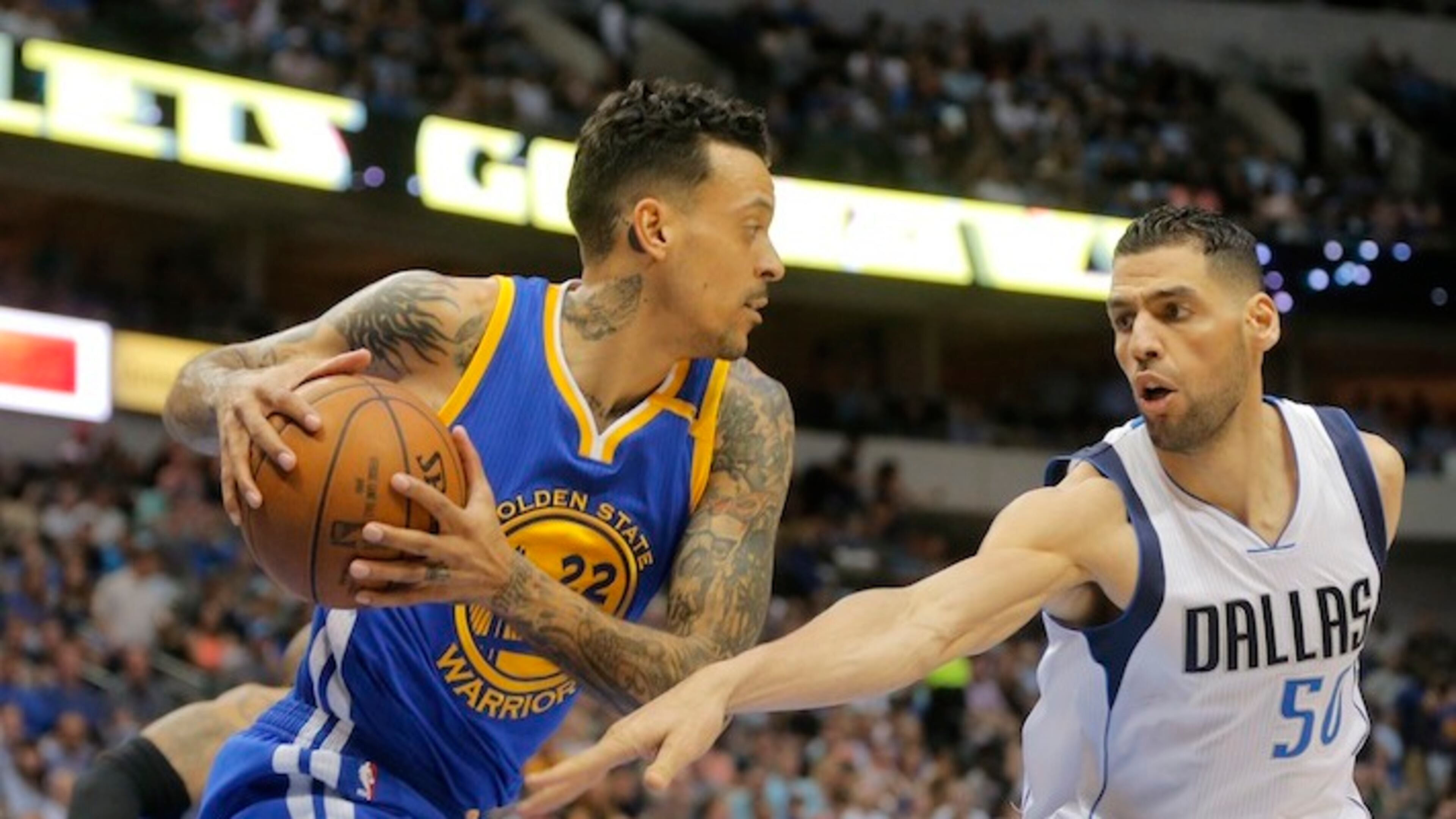 The Golden State Warriors' Matt Barnes (22) comes down with a rebound in front of the Dallas Mavericks' Salah Mejri (50) at American Airlines Center in Dallas on March 21, 2017. (Rodger Mallison/Fort Worth Star-Telegram/TNS)