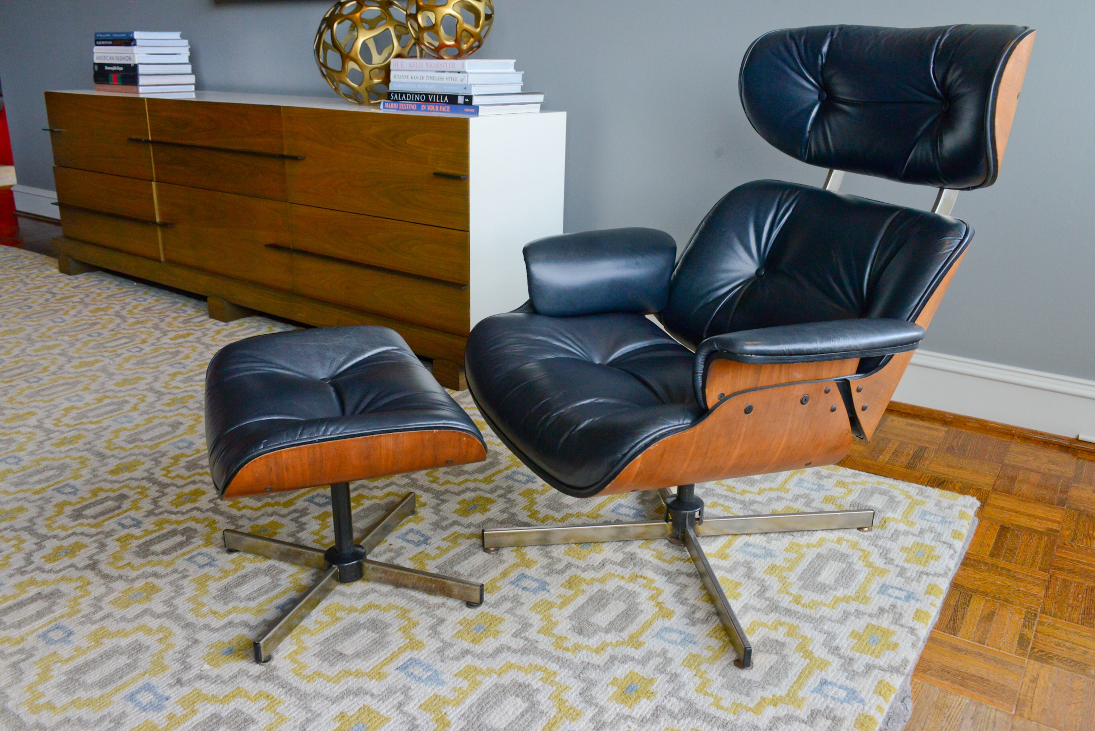 A vintage Eames chair from Decades Antiques and Vintage is among the mid-century modern furnishings in the Buckhead condo. It's next to a favorite piece of furniture - the Jiun Ho console table from R. Hughes.