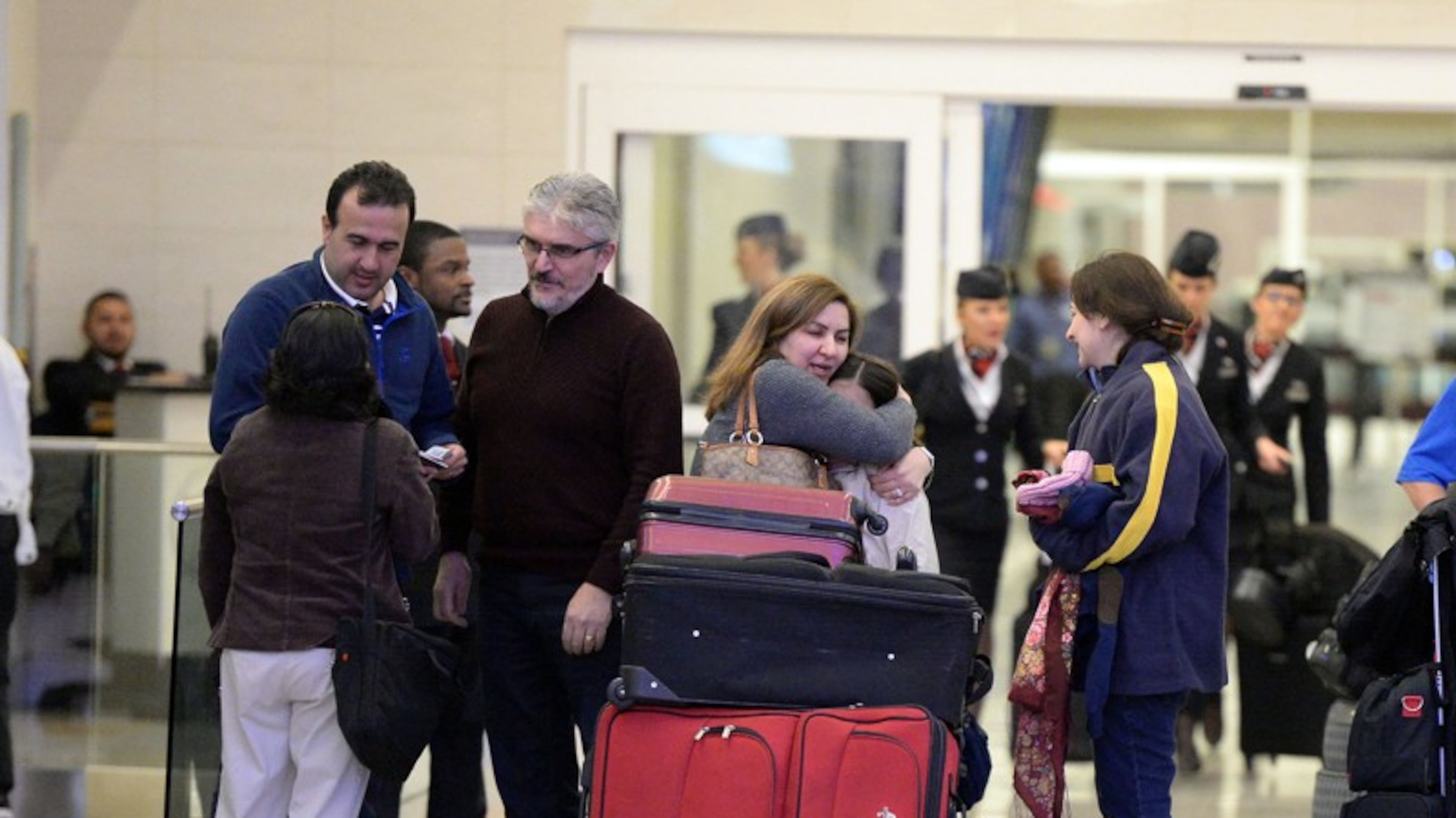 Mansour Kenareh (center in purple sweater) reunites with family members in the International arrivals lobby at Hartsfield-Jackson Atlanta International Airport Saturday January 25, 2017. The family of 3 were among several people detained at the U.S. Customs and Border Protection office following an executive order from President Trump limiting immigration. Kent D. Johnson/AJC