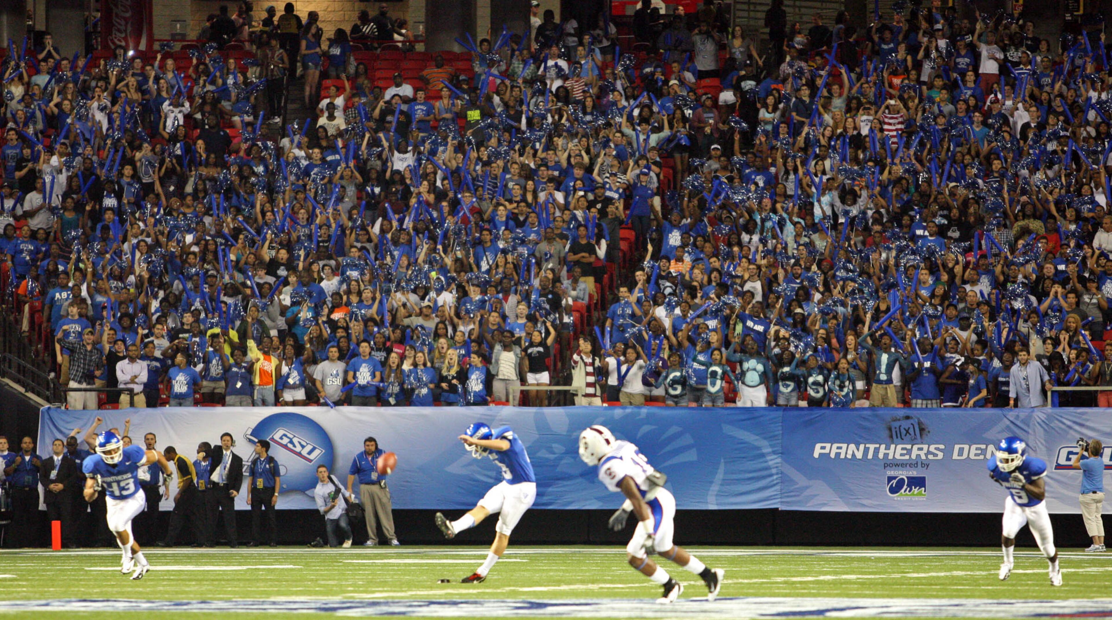 August 30, 2012 - Atlanta, Ga: Georgia State University students cheer as Georgia State University kicker David Miller kicks off to start their game against South Carolina State in the Georgia Dome Thursday night in Atlanta, Ga., August 30, 2012. JASON GETZ / JGETZ@AJC.COM