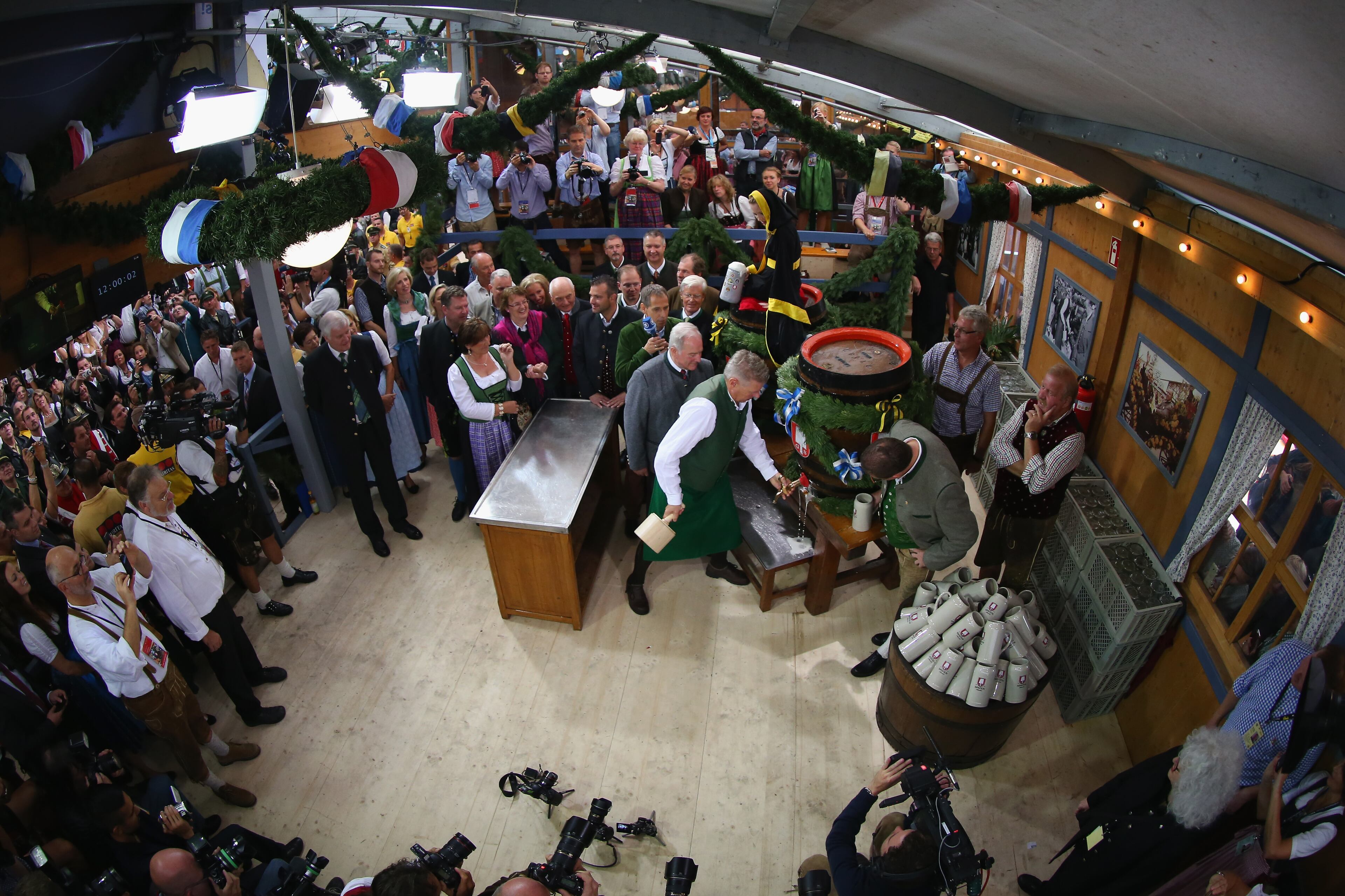 MUNICH, GERMANY - SEPTEMBER 20: Munich new Mayor Dieter Reiter uses a wooden hammer to pound a tap into the first Oktoberfest beer barrel at Schottenhamel beer tent on the opening day of the 2014 Oktoberfest at Theresienwiese on September 20, 2014 in Munich, Germany. The 181st Oktoberfest will be open to the public from September 20 through October 5 and traditionally draws millions of visitors from across the globe in the world's largest beer fest. (Photo by Alexander Hassenstein/Getty Images)