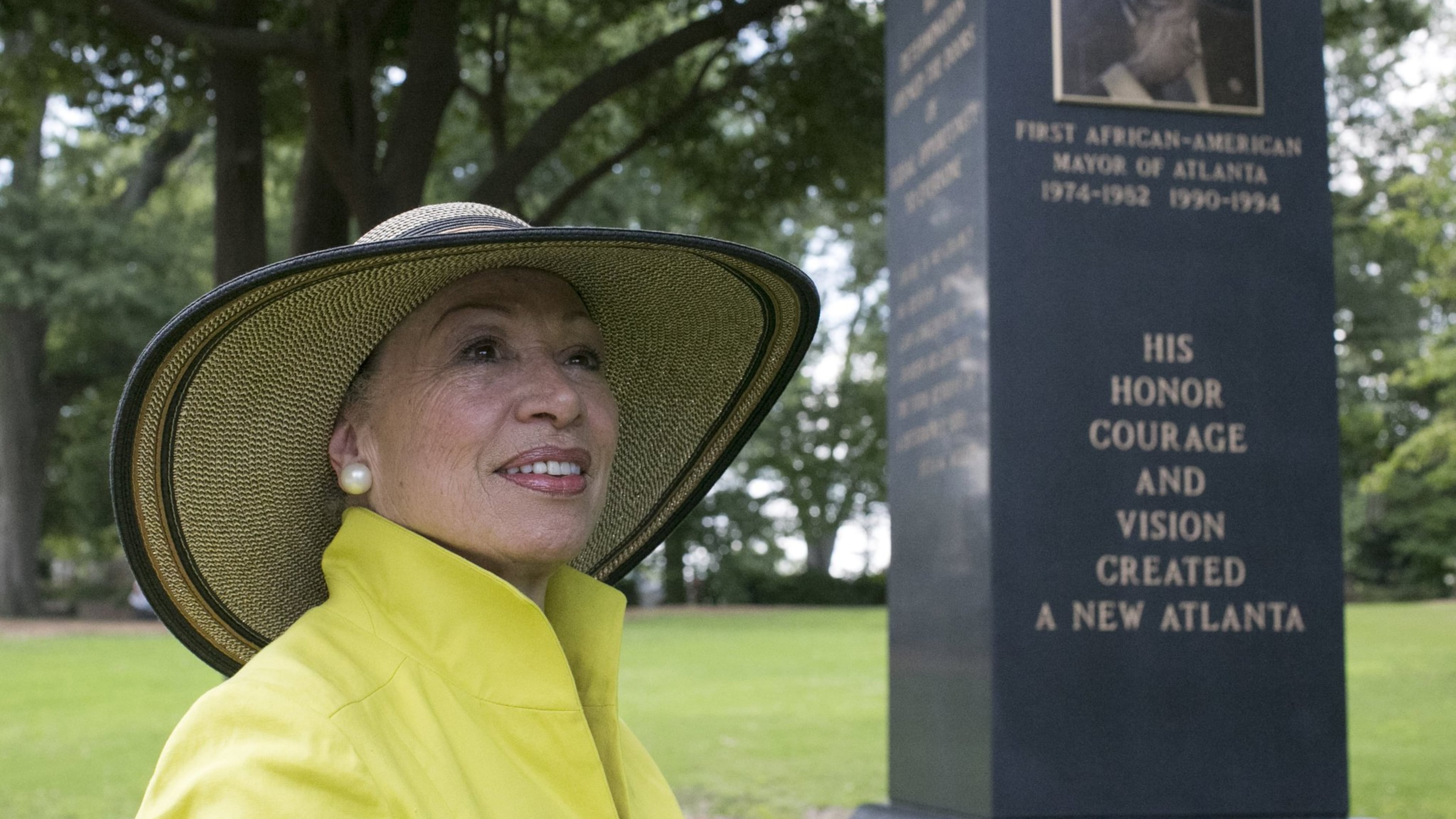 Valerie Jackson, the widow of Maynard Jackson, looks toward the Atlanta skyline, which the portrait of Maynard is facing, as she visited the 14.5-foot monument she erected on her husband’s gravesite at Oakland cemetery. BOB ANDRES /BANDRES@AJC.COM