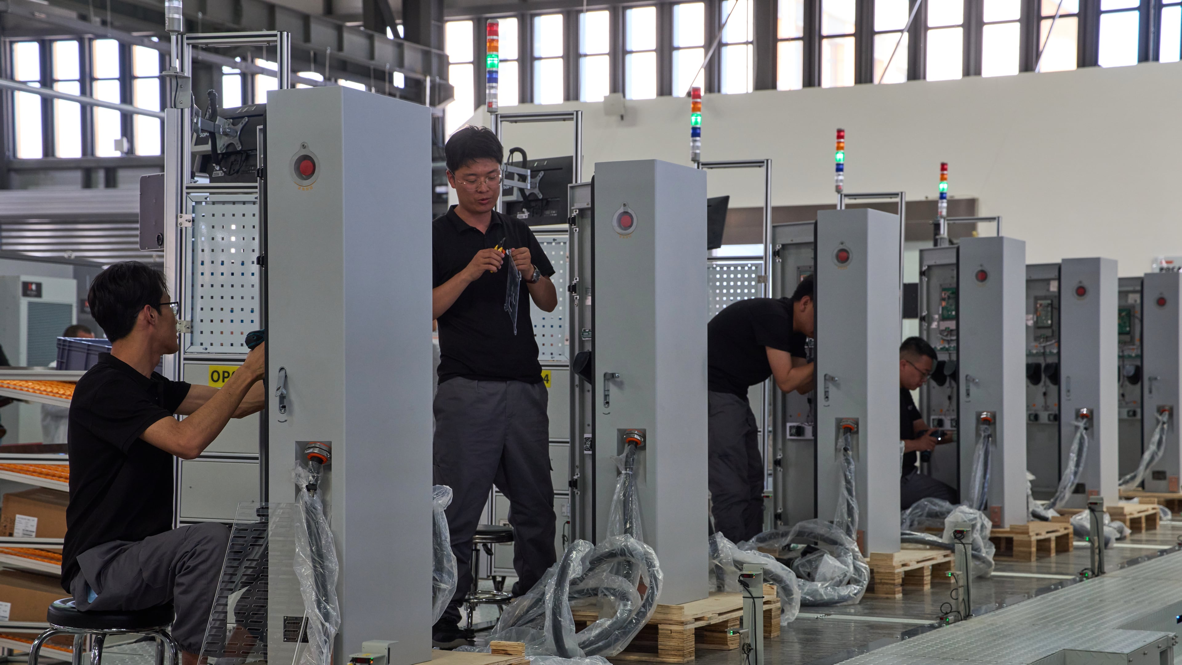 FILE - Workers assemble charging stations at the Mengma Intelligent Transportation Equipment Manufacturing Base in Hohot in northern China's Inner Mongolia province on Thursday, June 11, 2026. (AP Photo/Ng Han Guan, file)