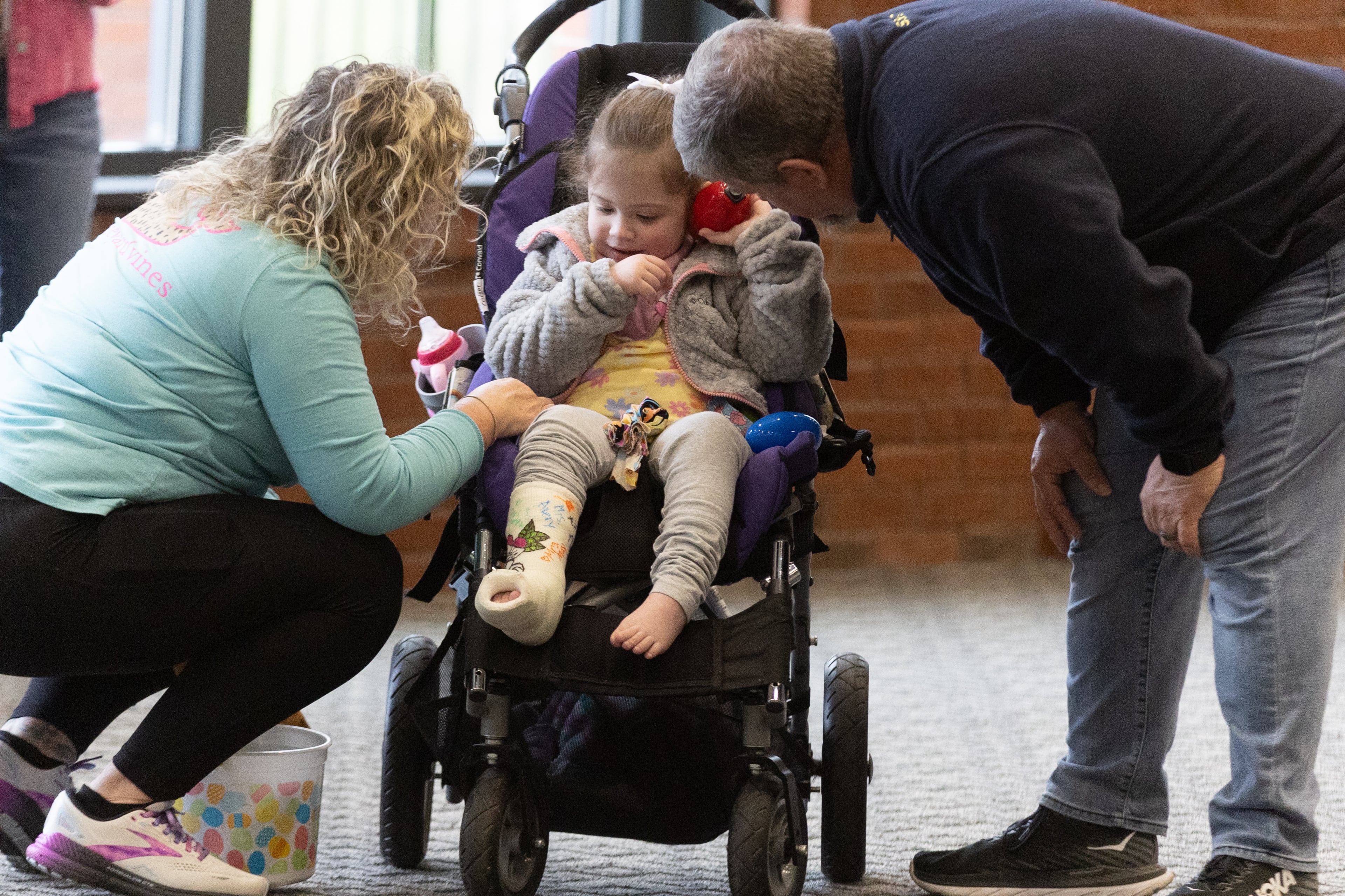 Cindy Chambers (L) watches her Granddaughter Kimberly Cook, six, as Kimberly listens to a beeping-modified Easter egg during the Beeping Easter Egg Hunt on Saturday at Acworth Community Center (Steve Schaefer/steve.schaefer@ajc.com)