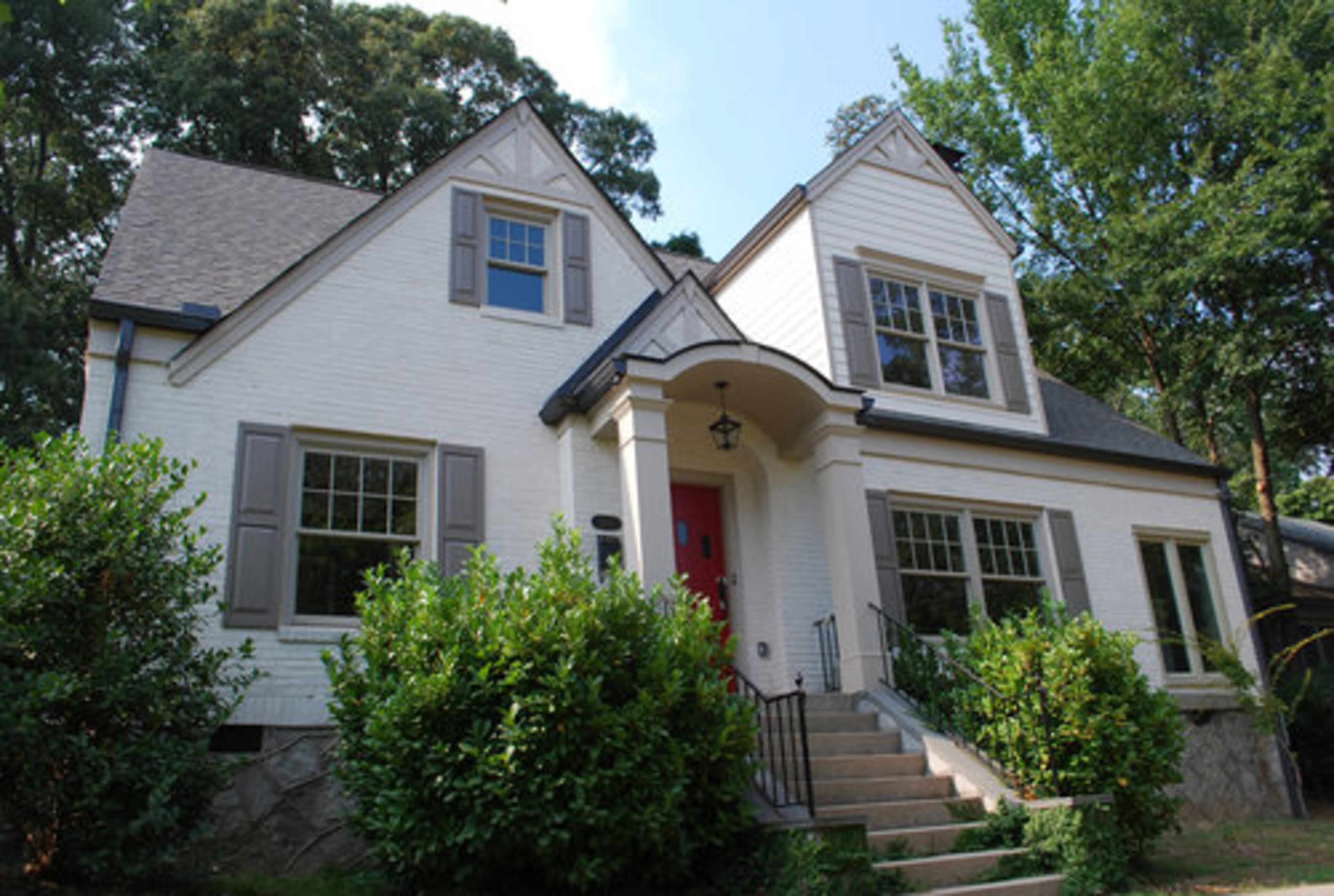 AFTER: It would be hard to guess from the outside that this second story addition to a Virginia Highlands home wasn't original especially with the discrete placement of a new dormer window. To further update the home, the homeowners opted to paint the outdated brick, which also helps integrate the second level.