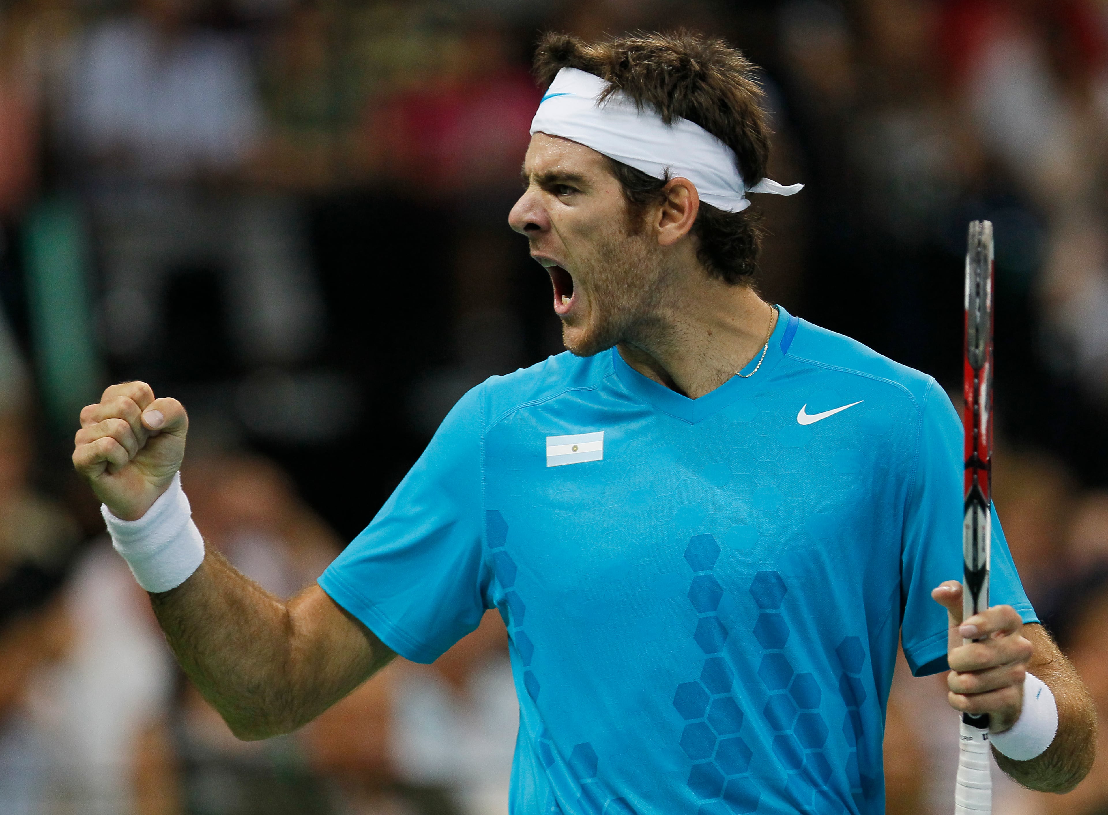 Juan Martin Del Potro of Argentina reacts after winning a point against Novak Djokovic of Serbia during the Davis Cup singles semi final between Serbia and Argentina at Belgrade Arena on Sept. 18, 2011, in Belgrade, Serbia.