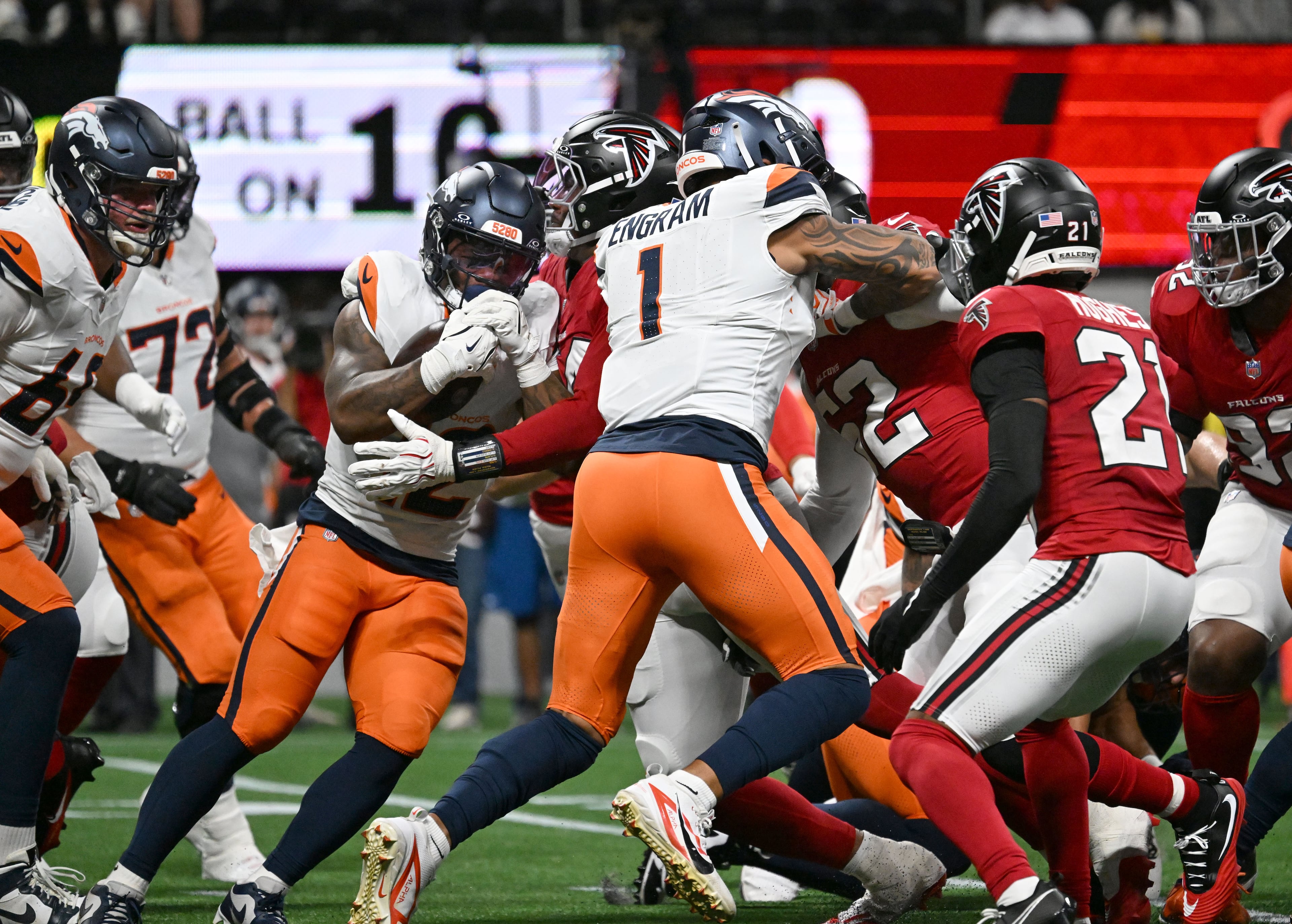 Broncos running back RJ Harvey (second from left) is stopped by Falcons defensive tackle Brandon Dorlus during their preseason game at Mercedes-Benz Stadium on Friday, Aug. 14, 2026, in Atlanta. (Hyosub Shin/AJC)