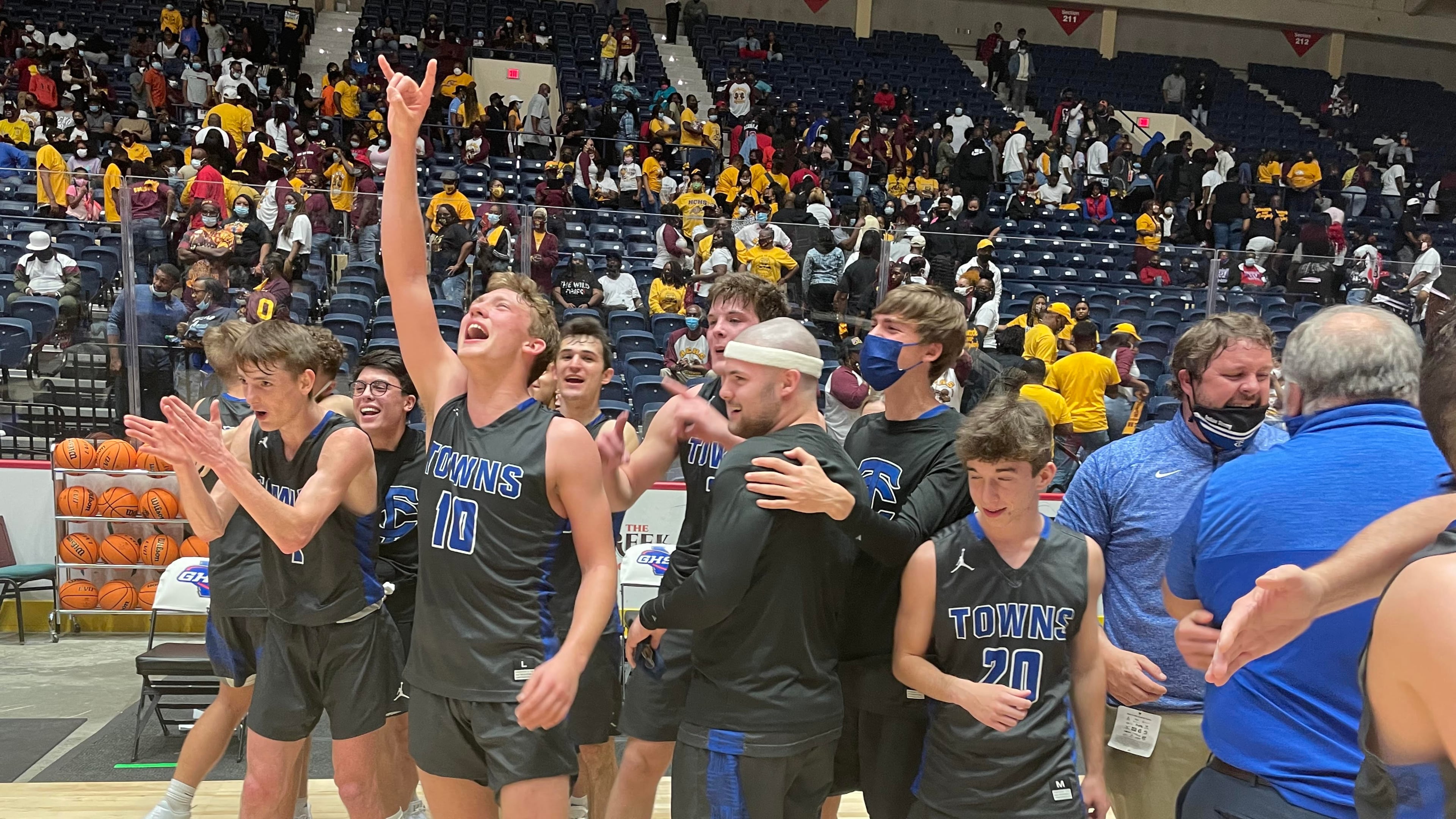 Towns County players and coaches celebrate their 64-60 victory over Hancock Central in the Class A Public boys basketball championship game Saturday, March 13, 2021, at Macon Coliseum.