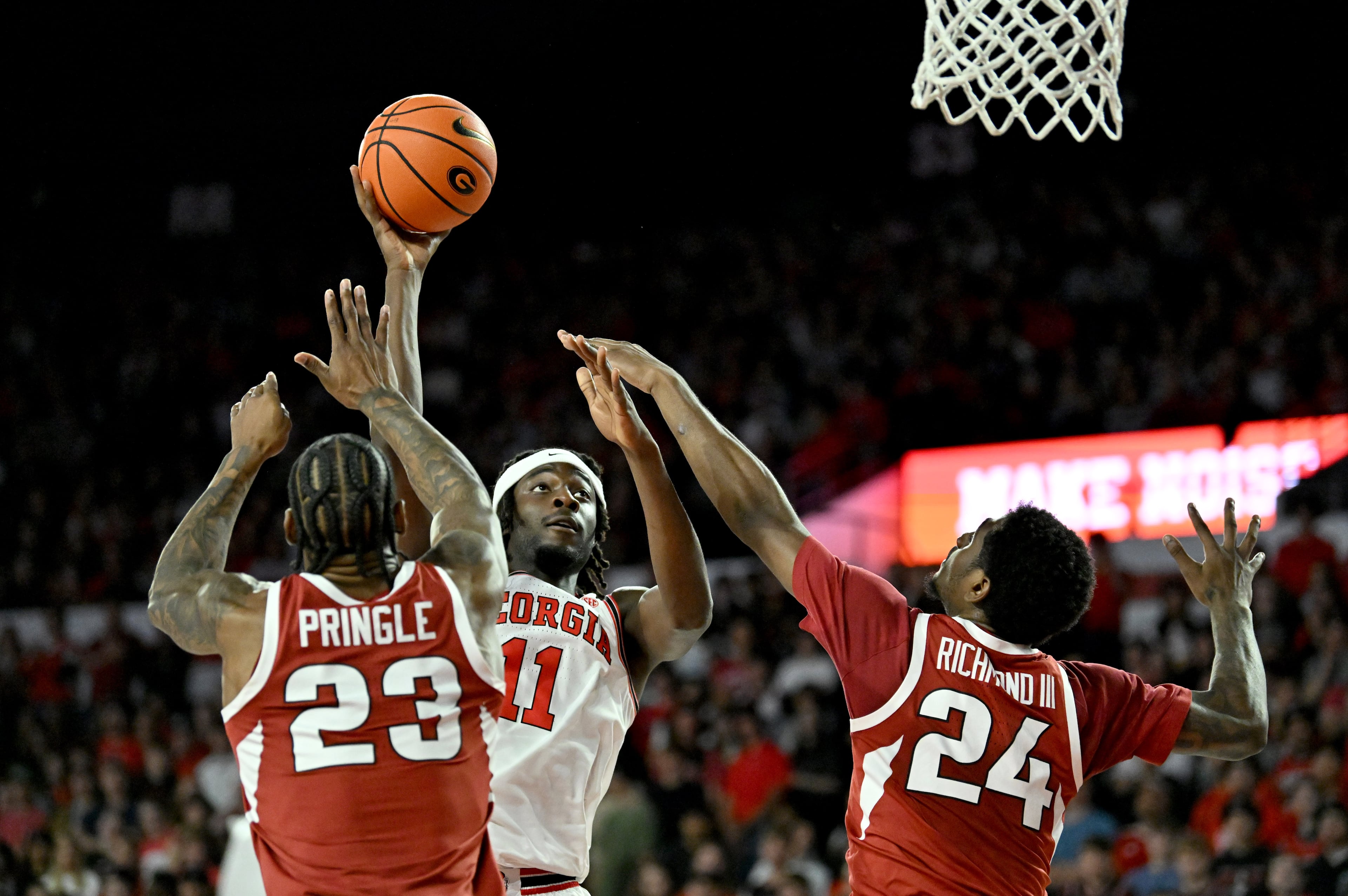 Georgia forward Dylan James shoots over Arkansas forward Billy Richmond III (right) during the first half in an NCAA college basketball game at Stegeman Coliseum, Saturday, Jan. 17, 2026, in Athens. (Hyosub Shin/AJC)