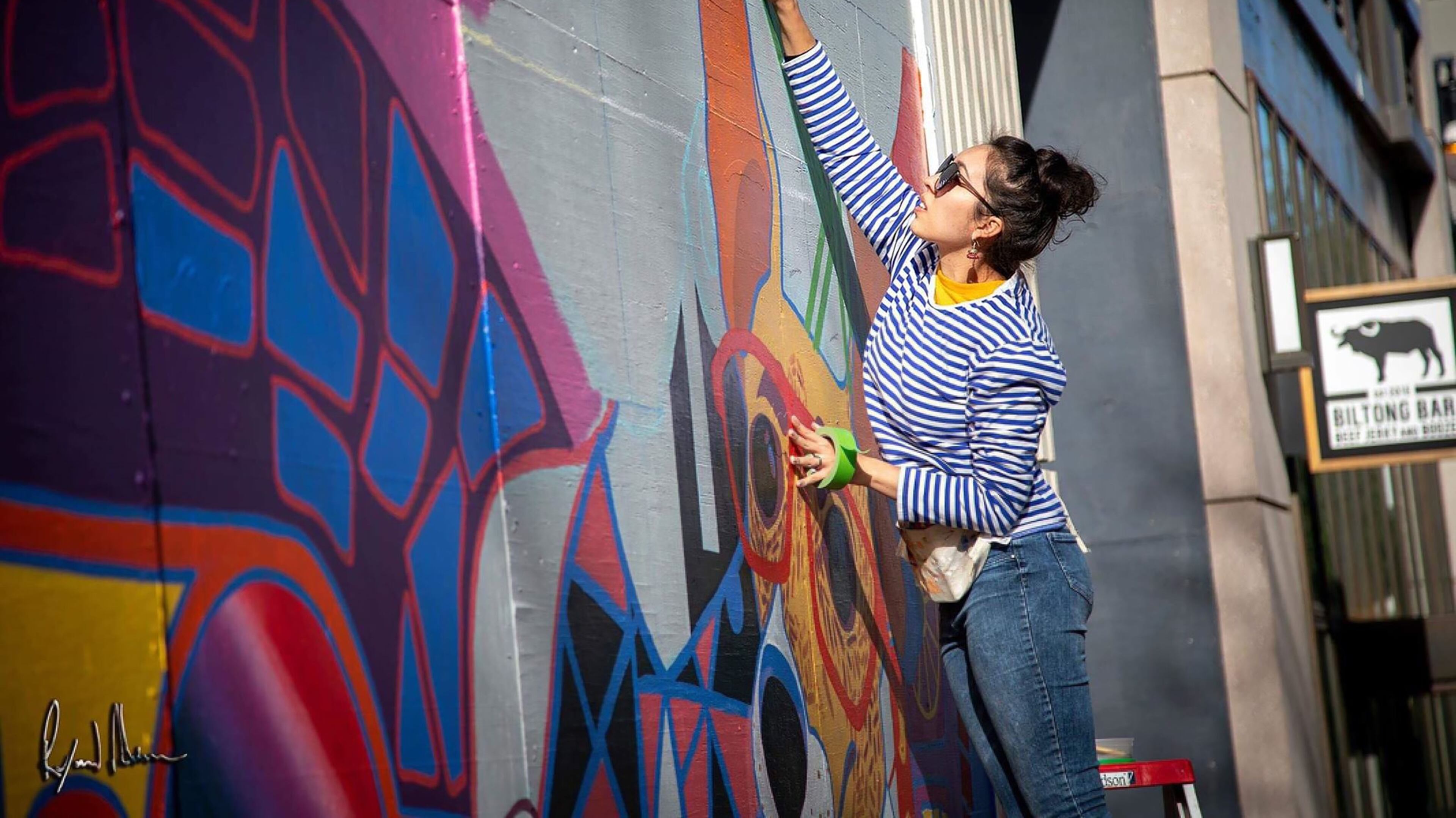 Carla Contreras at work on her mural for the Shops Buckhead Atlanta. Photo credit: Carla Contreras