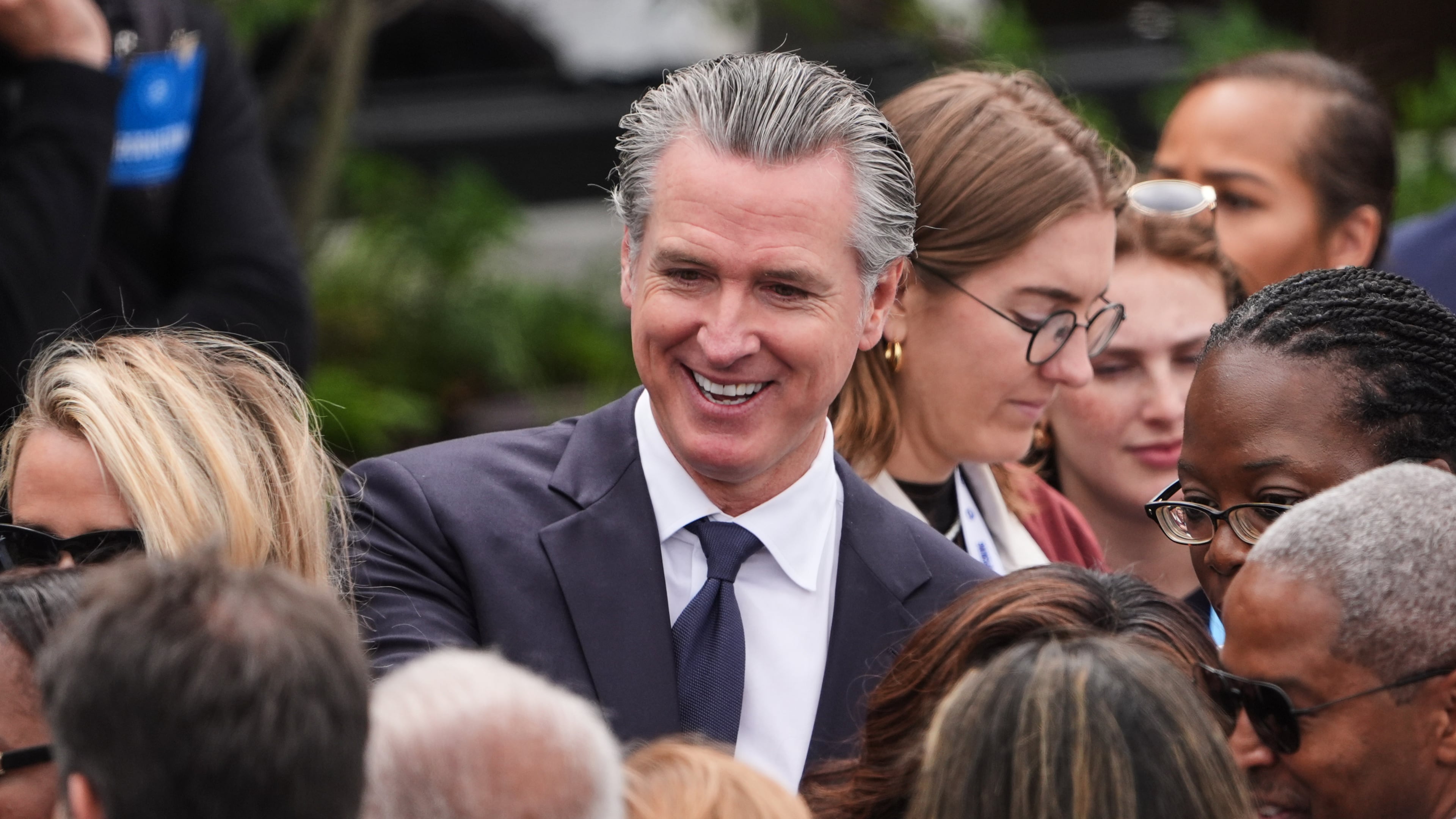California Gov. Gavin Newsom mingles ahead of the Obama Presidential Center dedication ceremony Thursday, June 18, 2026, in Chicago. (AP Photo/Jeff Roberson)