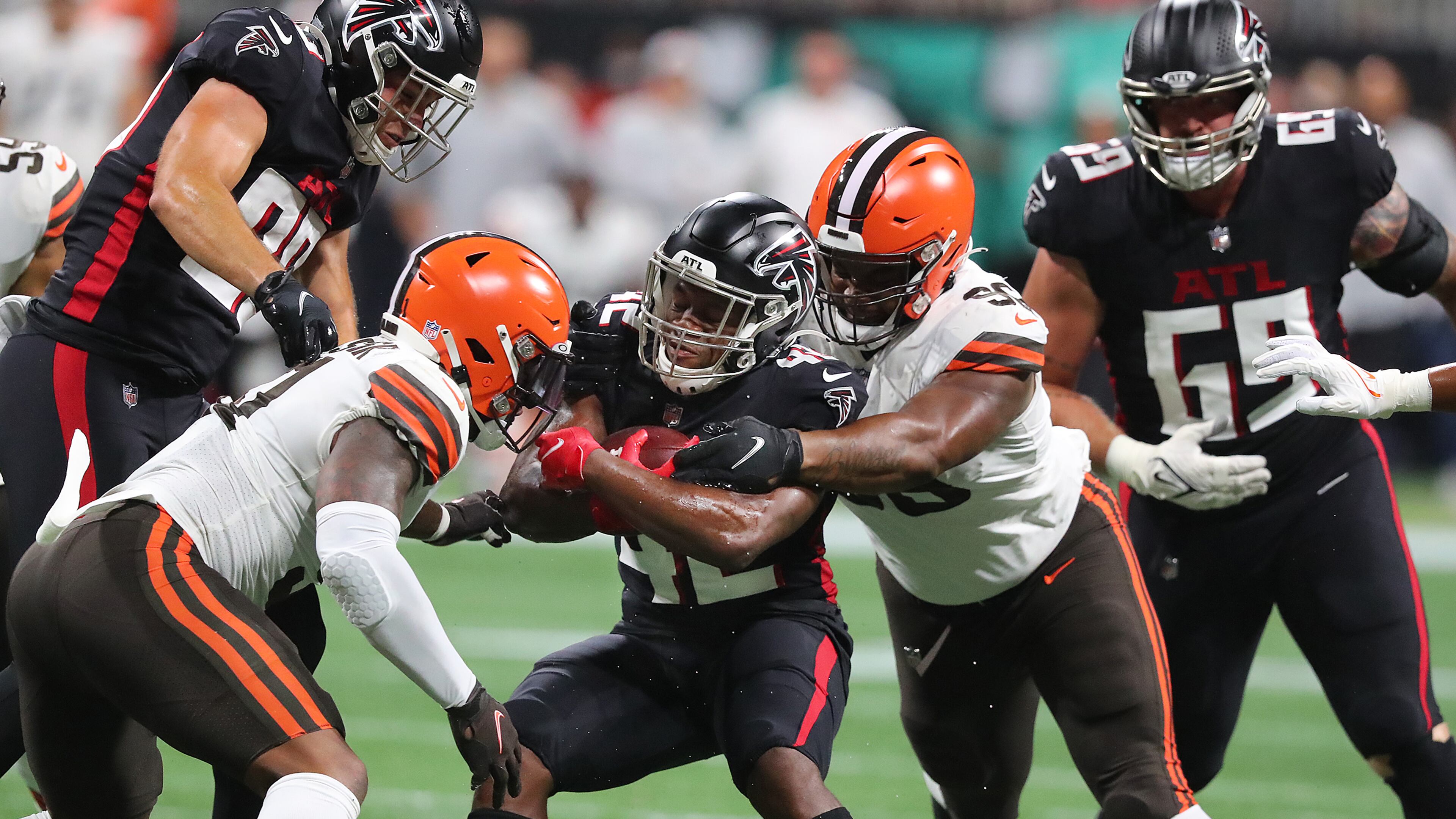 Falcons running back Caleb Huntley is sandwiched by Cleveland Browns defenders for short yardage during the first half Sunday, Aug. 29, 2021, in Atlanta. “Curtis Compton / Curtis.Compton@ajc.com”