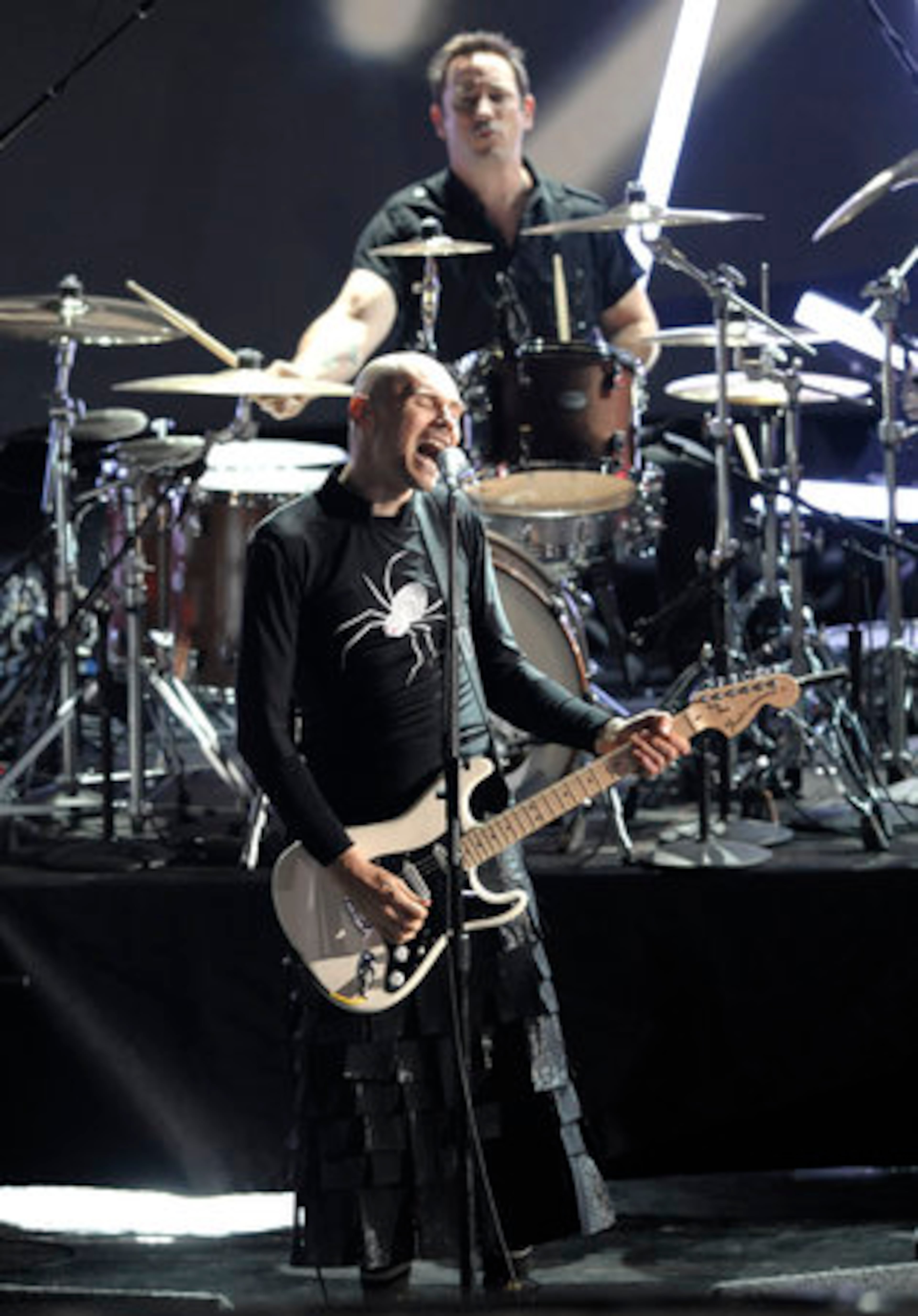 Billy Corgan of Smashing Pumpkins performs in some sort of patchwork kilt.