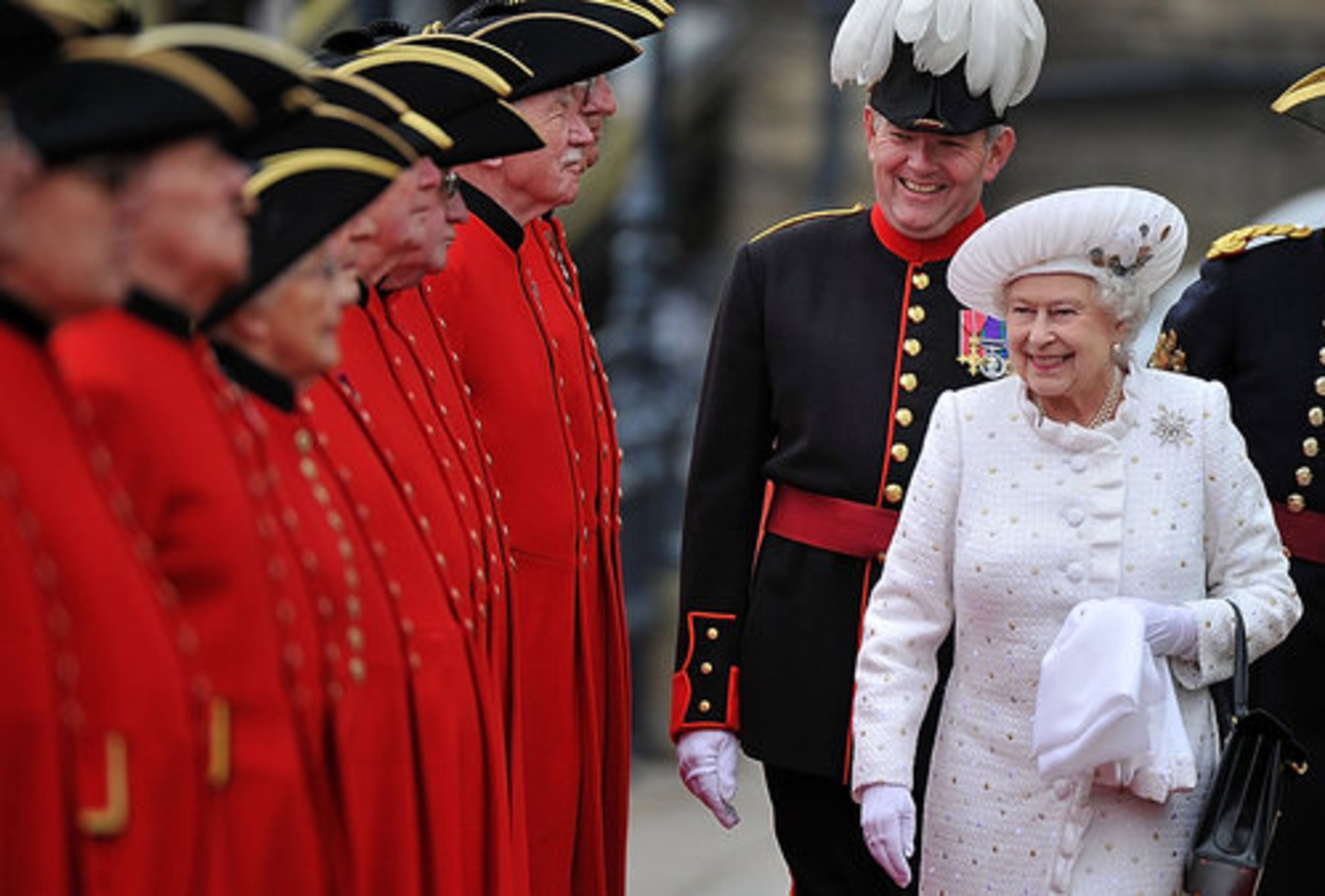 Britain's Queen Elizabeth II, right, arrives at Chelsea Pier in London, before boarding the royal barge to participate in the Diamond Jubilee River Pageant Sunday June 3, 2012.