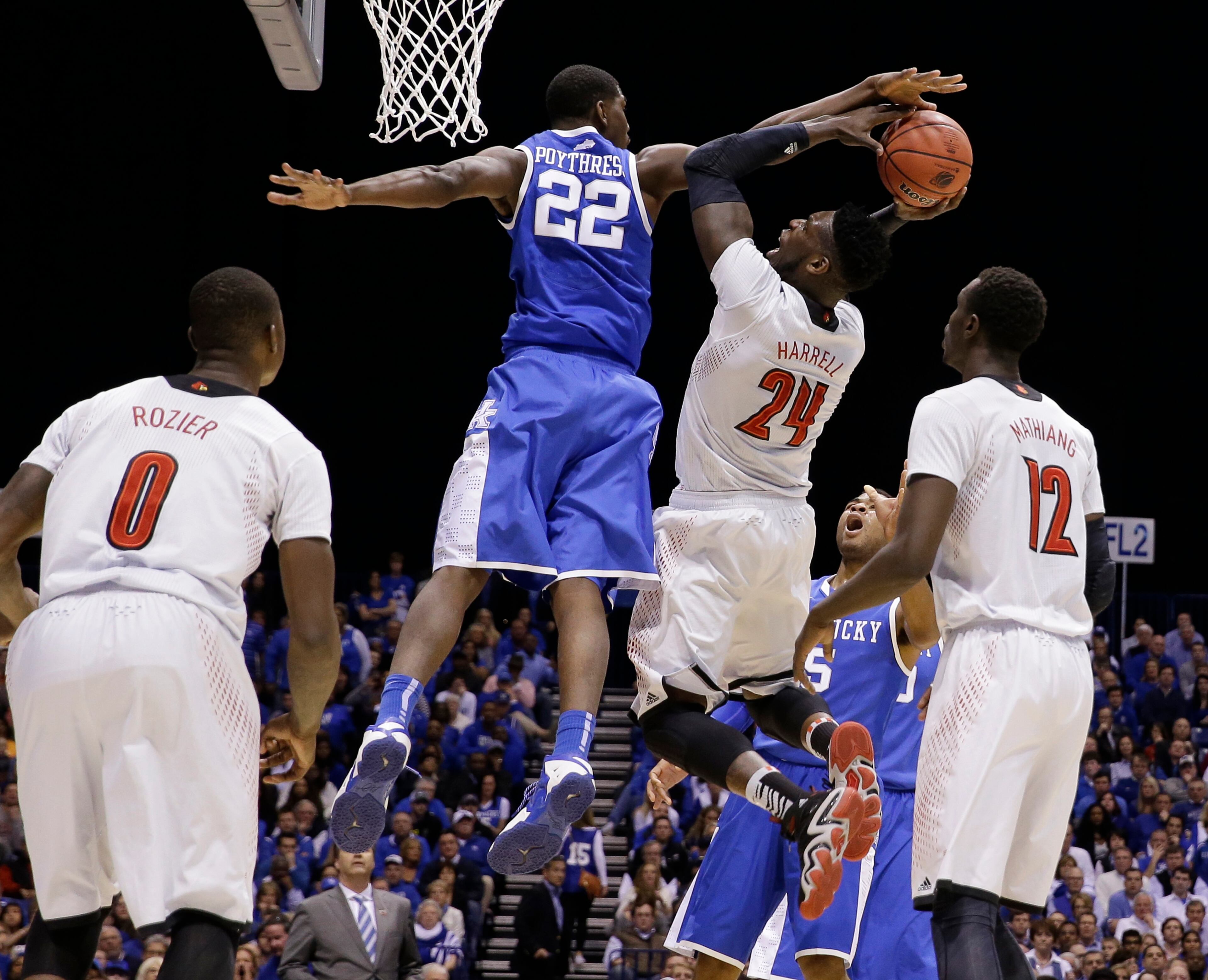 Kentucky's Alex Poythress (22) locks the shot of Louisville's Montrezl Harrell (24) during the first half of an NCAA Midwest Regional semifinal college basketball tournament game Friday, March 28, 2014, in Indianapolis.