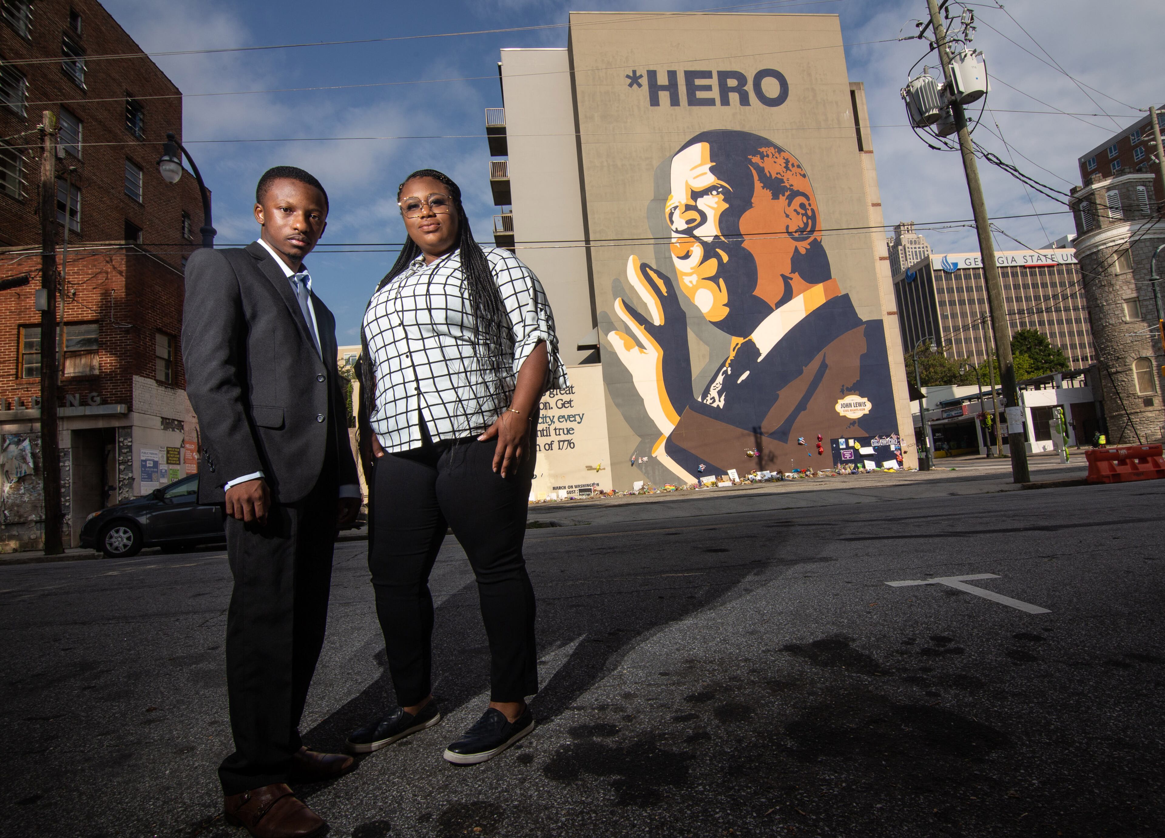 Mary-Pat Hector (R) and Jared Sawyer pose for a photograph in front of the John Lewis mural on Auburn Ave in Atlanta, August 6, 2020. STEVE SCHAEFER FOR THE ATLANTA JOURNAL-CONSTITUTION