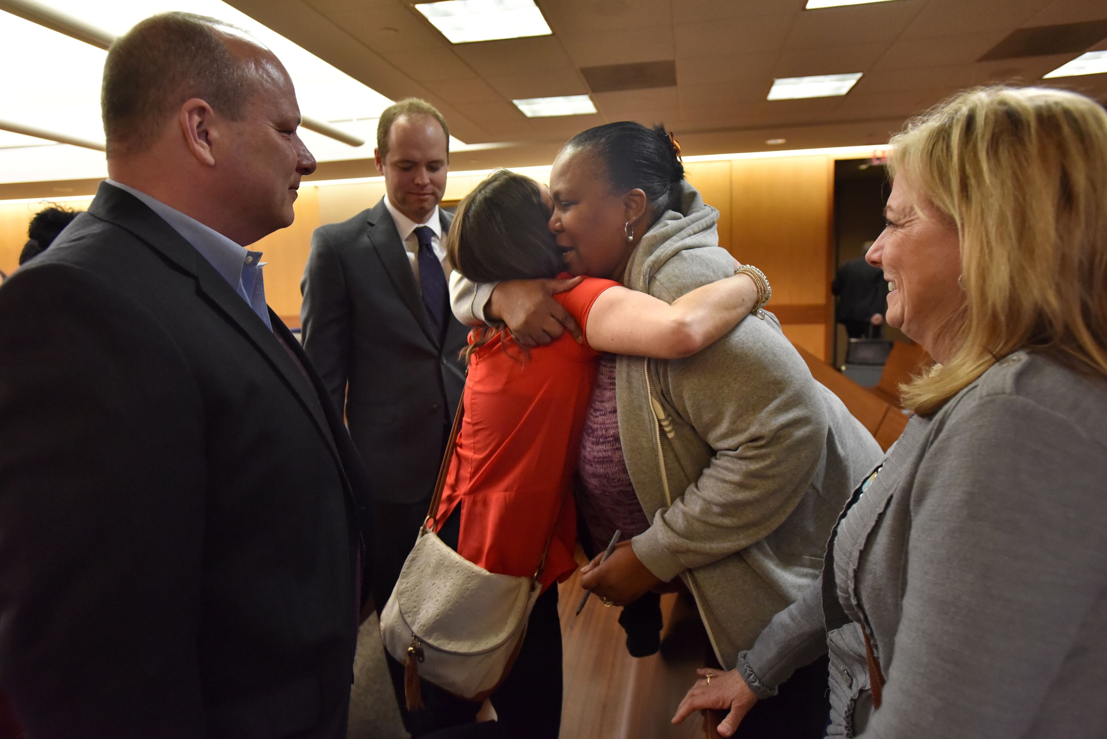 Chandra Duncan, aunt of defendants Trequan Sutton and Quindarius Slade, hugs Whitney Lash at Fulton County Superior Court on Thursday, Jan. 28, 2016. HYOSUB SHIN / HSHIN@AJC.COM