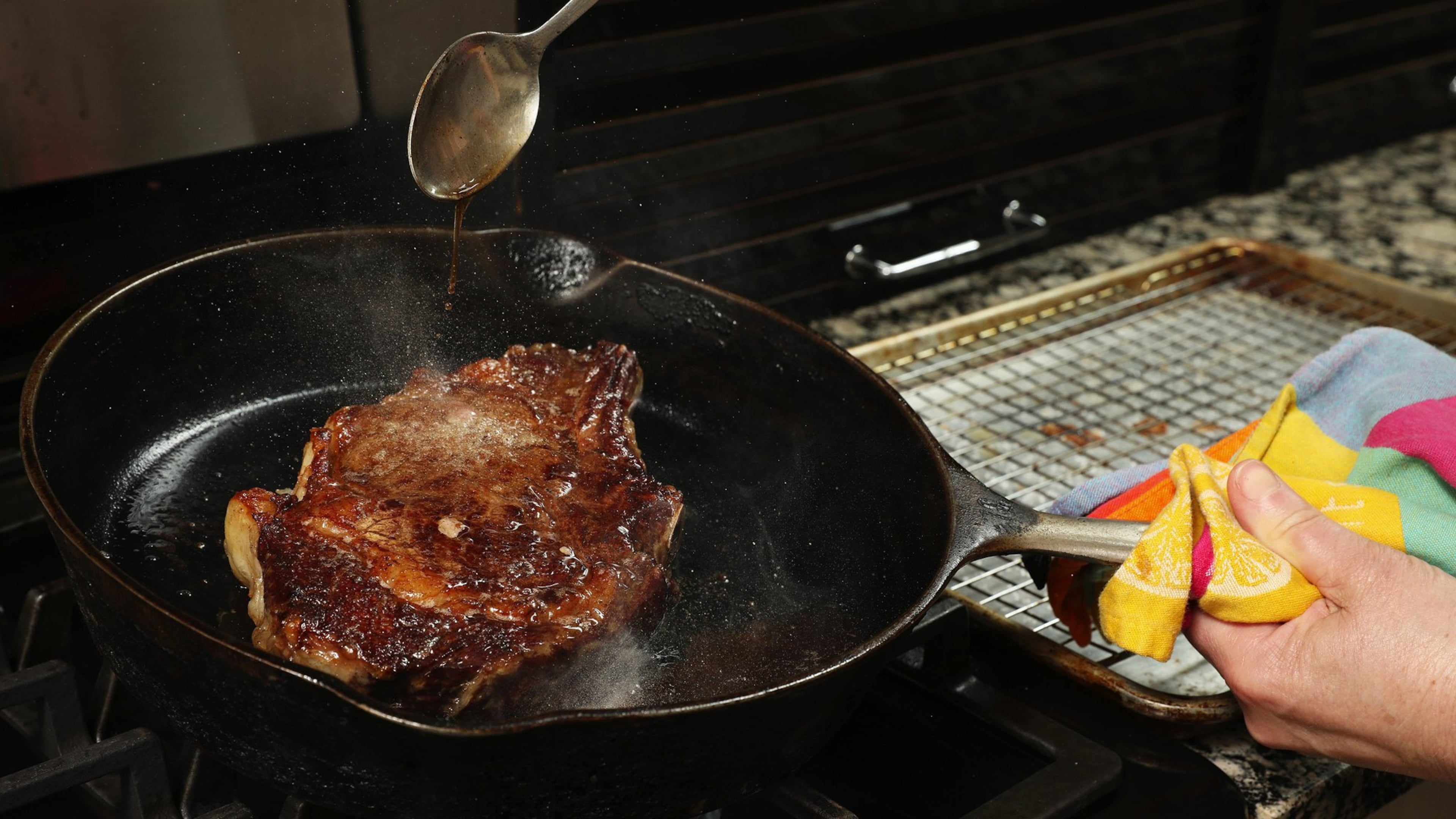 The steak cooks low and slow, at 225 degrees, in the oven until the middle reaches 110 degrees. Then it’s browned in a hot skillet, while being basted with butter to help promote the browning. (Chris Walker/Chicago Tribune/TNS)