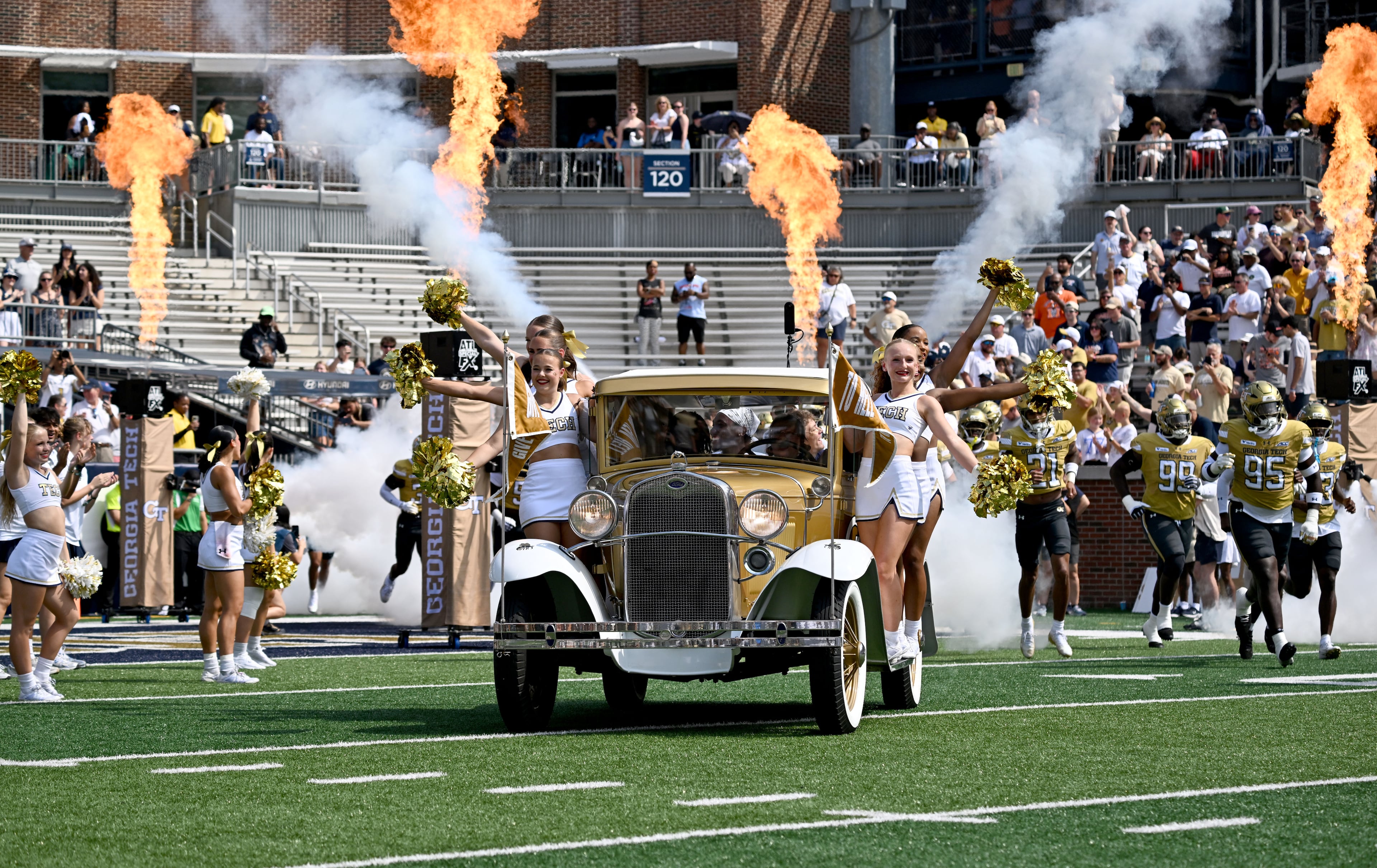 Georgia Tech's Ramblin' Wreck leads the band, cheerleaders, Buzz, players, and coaches before the start of the Georgia Tech home game against Mercer at Bobby Dodd Stadium on Saturday, Sept. 19, 2026, in Atlanta. (Hyosub Shin/AJC)
