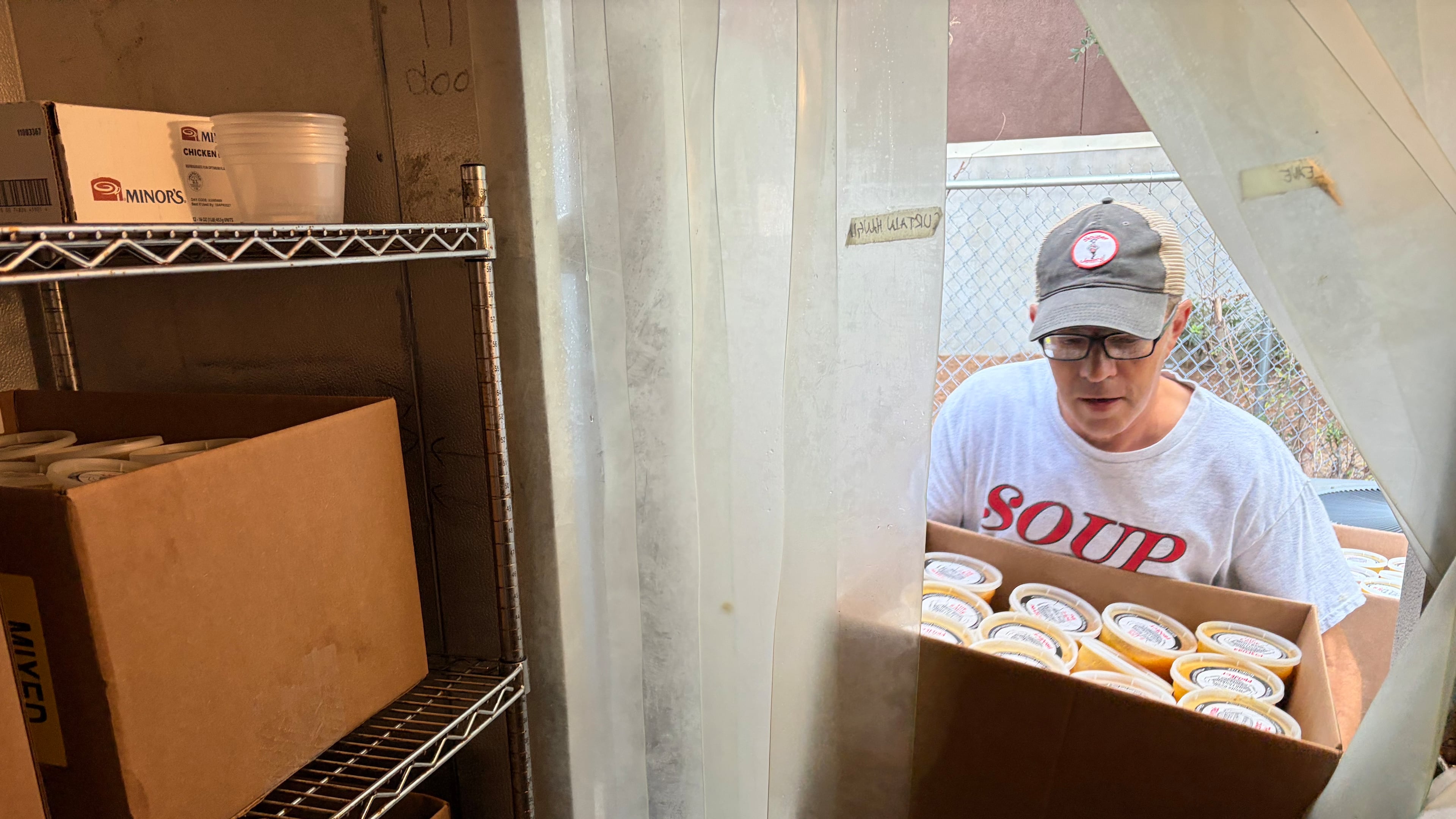 Keith Yaeger, director of operations for Souper Jenny, transfers soup to a freezer. The restaurant and its Zadie Project charity donated 100 quarts of soup to Morehouse School of Medicine students who are struggling to afford food because of a financial aid processing delay. (Jason Armesto/AJC)