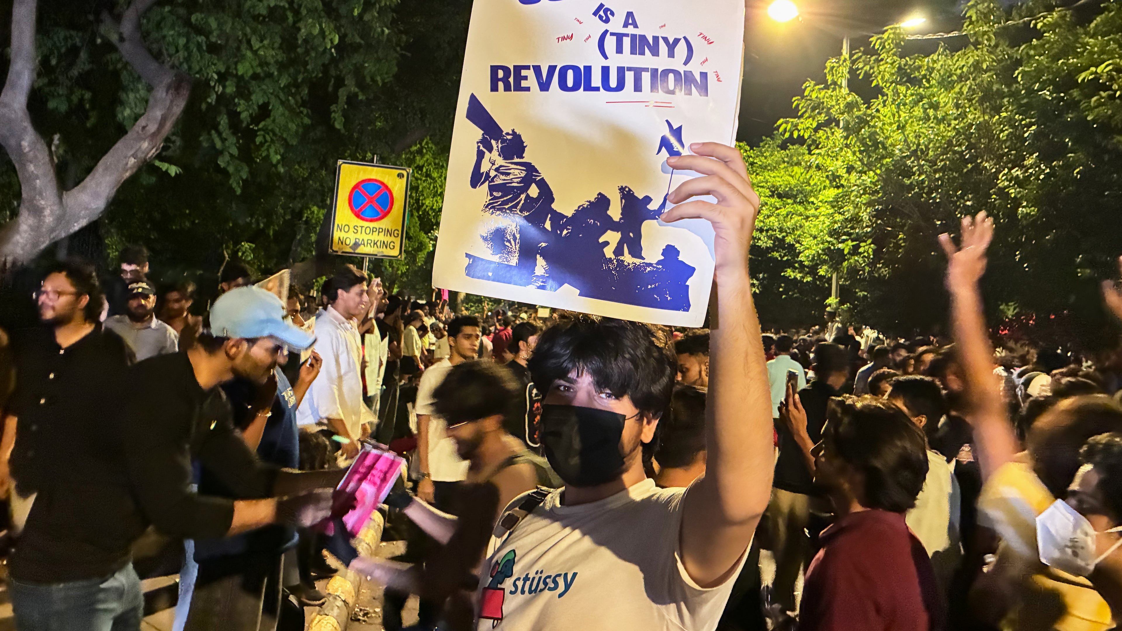 A protestor holds a placard with the message "Every Joke is a Tiny Revolution" during a demonstration demanding educational reforms as part of the Cockroach Janta Party's ongoing protest movement in New Delhi, India, Thursday, July 23, 2026. (AP Photo/Verda Sabzwari)